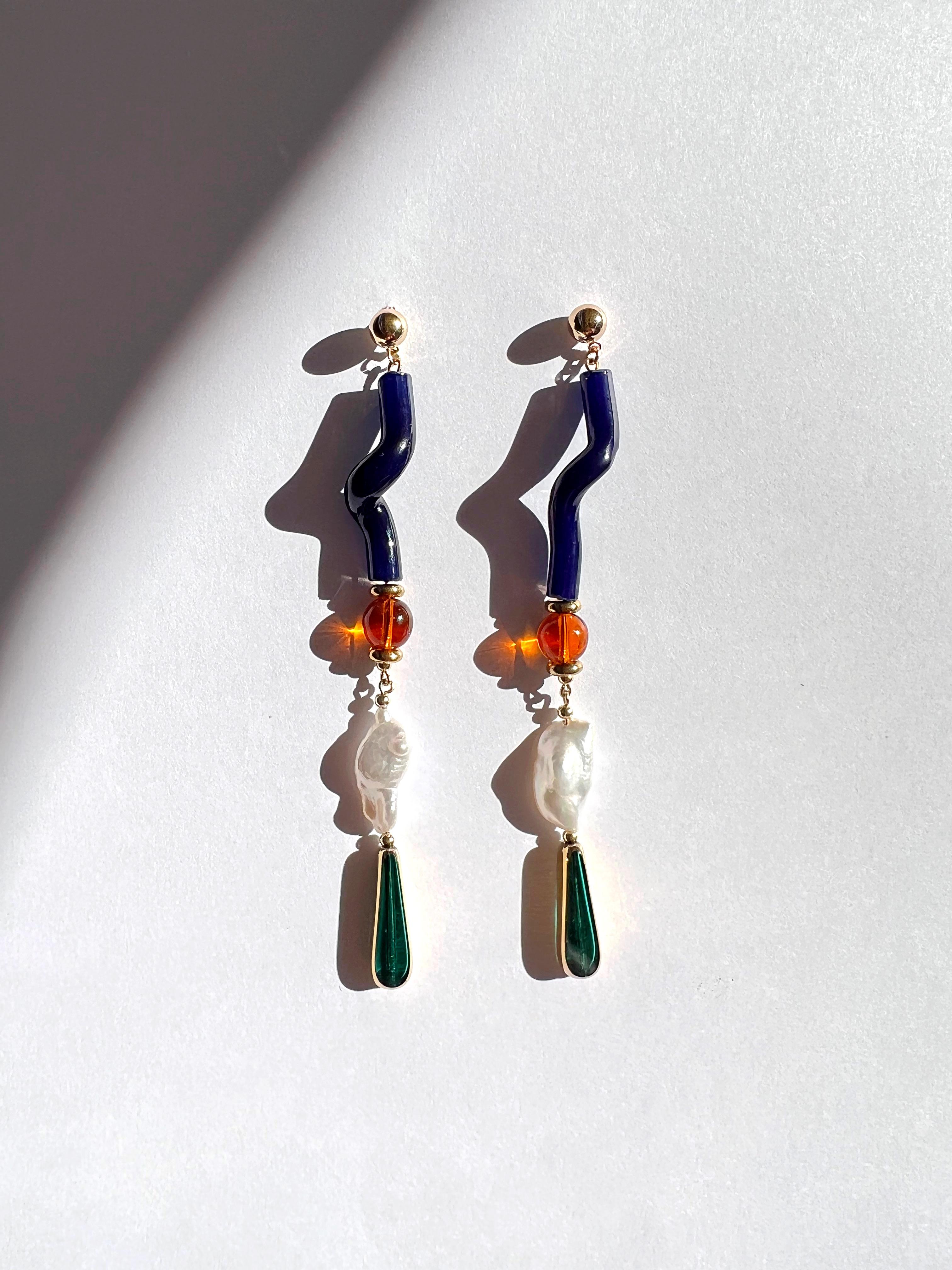 These gorgeous earrings is even more stunning when the light shines through. These earrings sway with movement. They are composed of biwa pearls, amber colored glass beads, vintage twisted glass bead and complimented with 24K vintage German glass