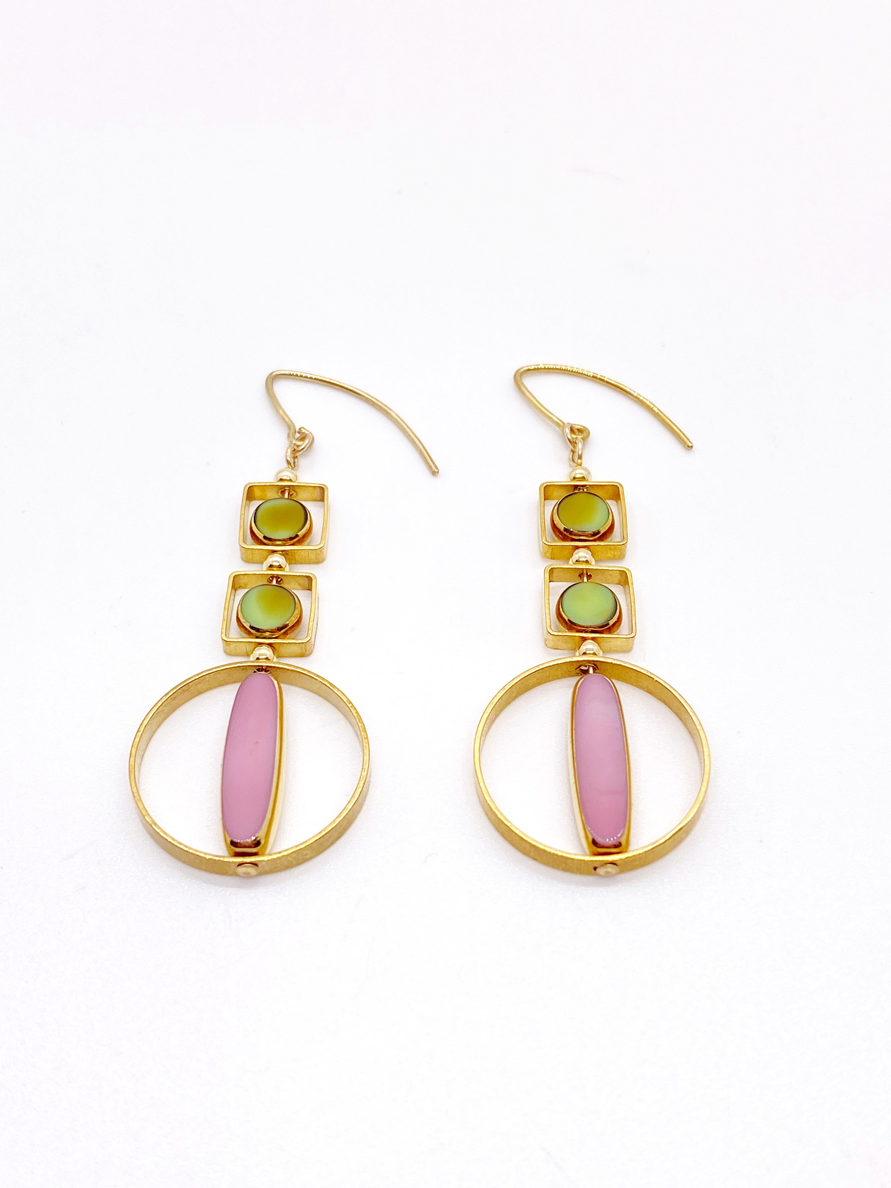 This is for a set of earrings. The earrings consist of pink oblong and marbled green mini circle shaped beads. They are new old stock vintage German glass beads that are framed with 24K gold. The beads were hand pressed during the 1920s-1960s. No