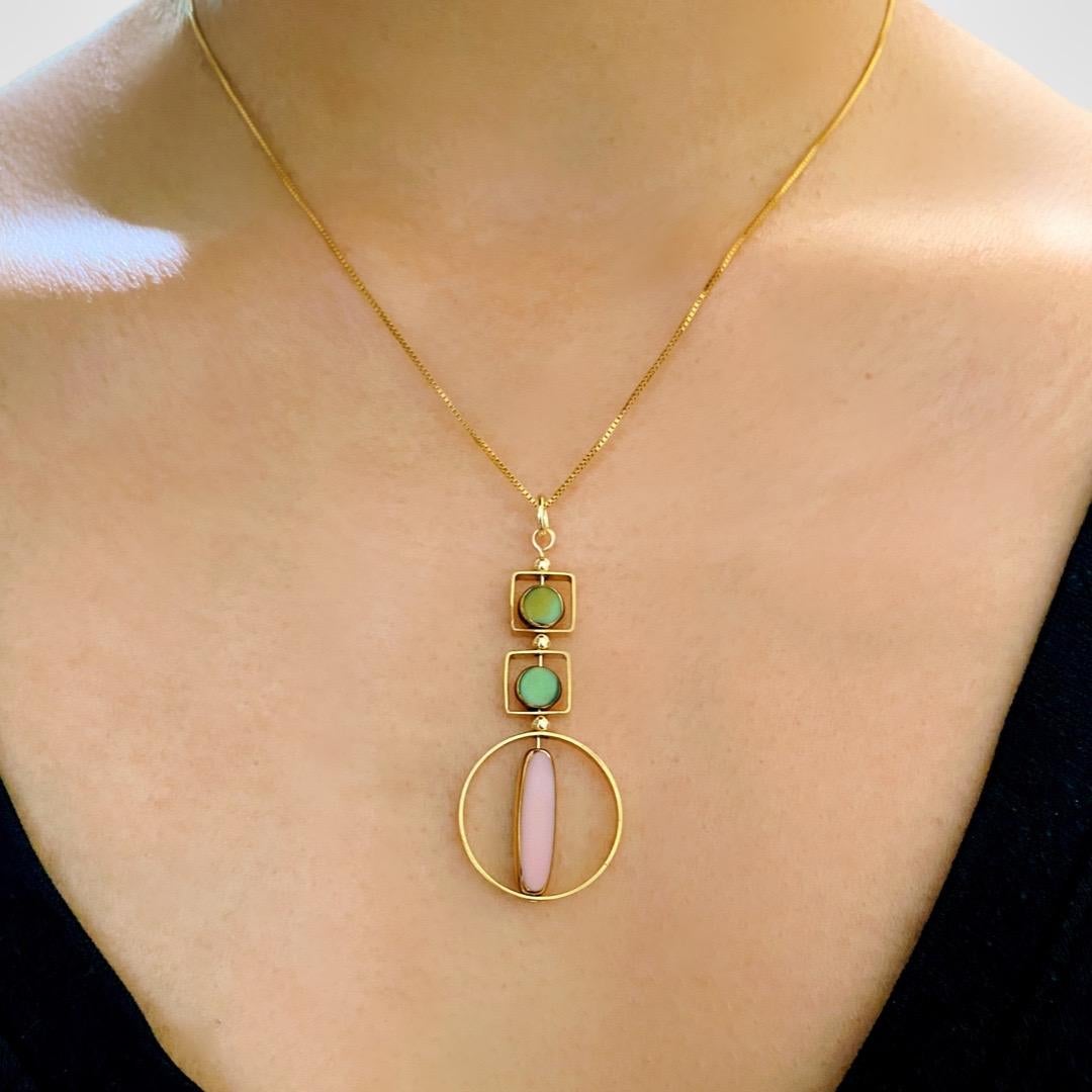 The pendant consist of pink oblong and 2 marbled green mini circle shaped beads and finished with a 18 inch gold filled chain. Shown on photo is with a 16 inch gold-filled chain.

The beads are new old stock vintage German glass beads that are