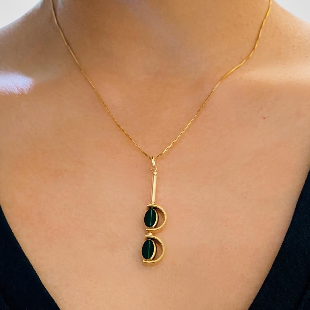 The pendant consist of 2 mini emerald  green oval shaped beads and finished with a 16 inch gold-filled chain. 

The beads are new old stock vintage German glass beads that are framed with 24K gold. The beads were hand pressed during the 1920s-1960s.