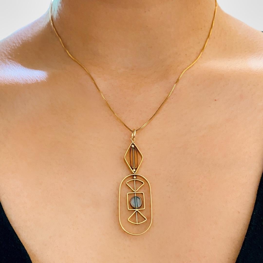 The pendant consist of  1 mini blue circle and 1 mini oblong shaped transparent beads and finished with a 16 inch gold filled chain. 

The beads are new old stock vintage German glass beads that are framed with 24K gold. The beads were hand pressed