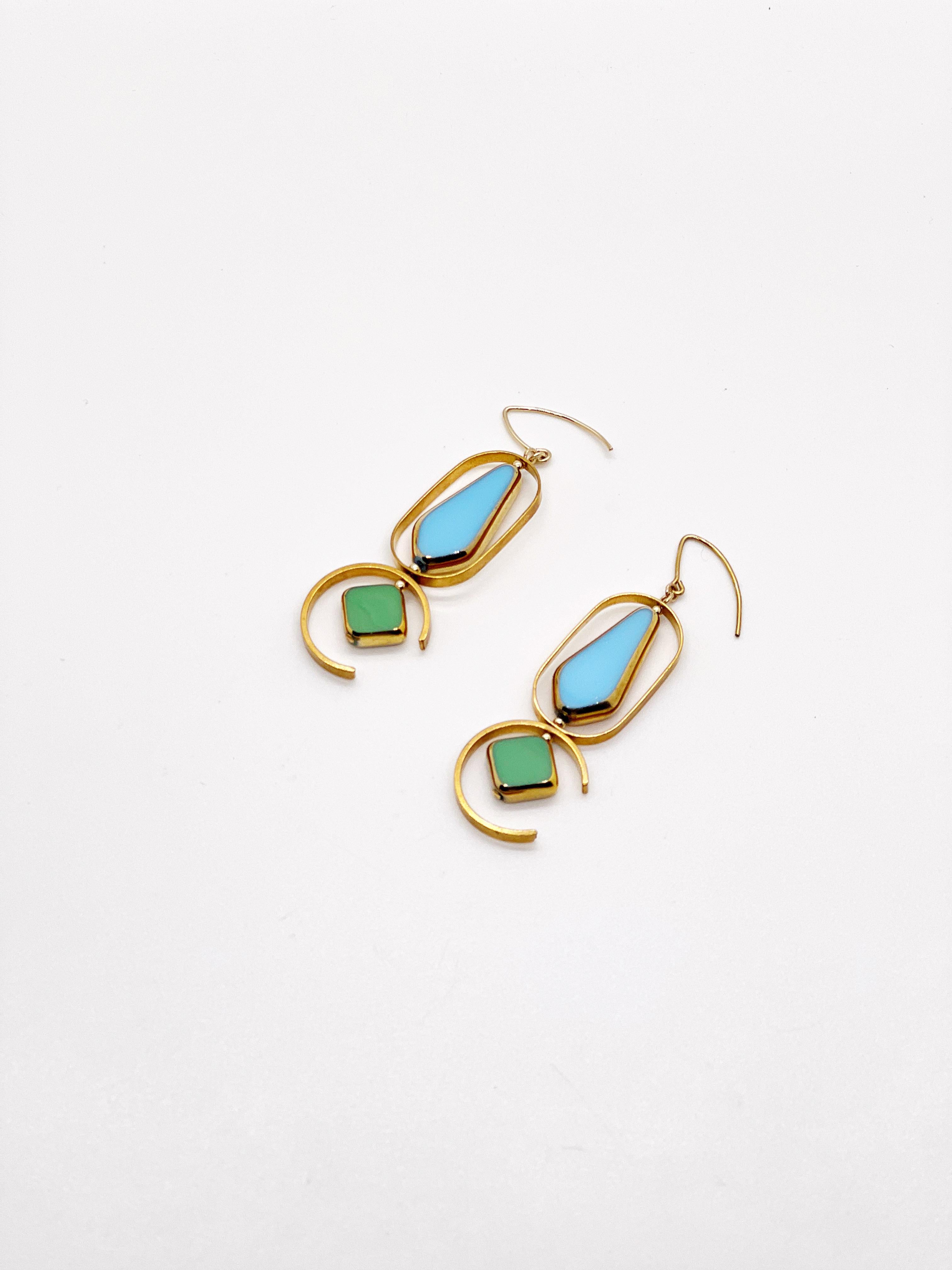 The earrings consist of large baby blue arrow and green diamond shaped beads. They are new old stock vintage German glass beads that are framed with 24K gold. The beads were hand pressed during the 1920s-1960s. No two beads are exactly alike. These