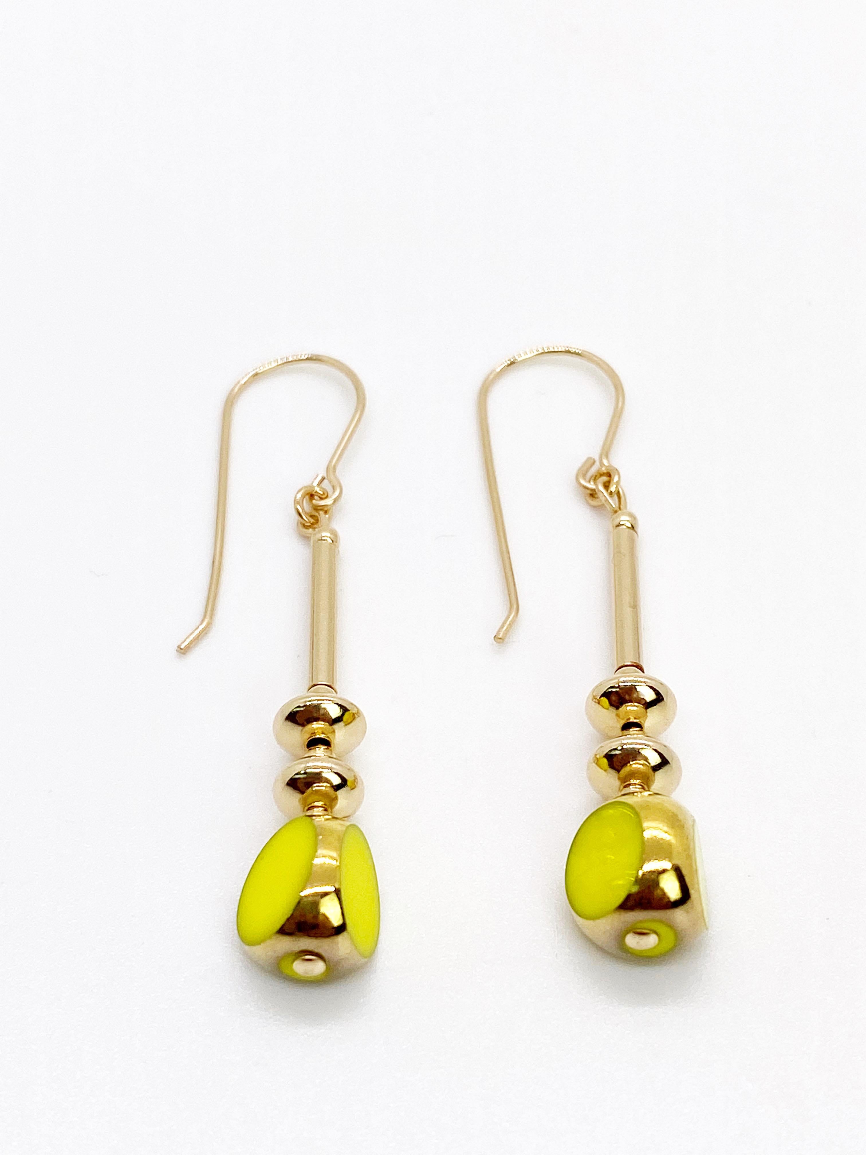Les boucles d'oreilles sont composées chacune d'une belle et brillante perle de verre opaque Chartreuse. Les perles de verre vintage allemandes sont encadrées d'or 24K, ainsi que de perles et de fils métalliques remplis d'or.

Les perles de verre