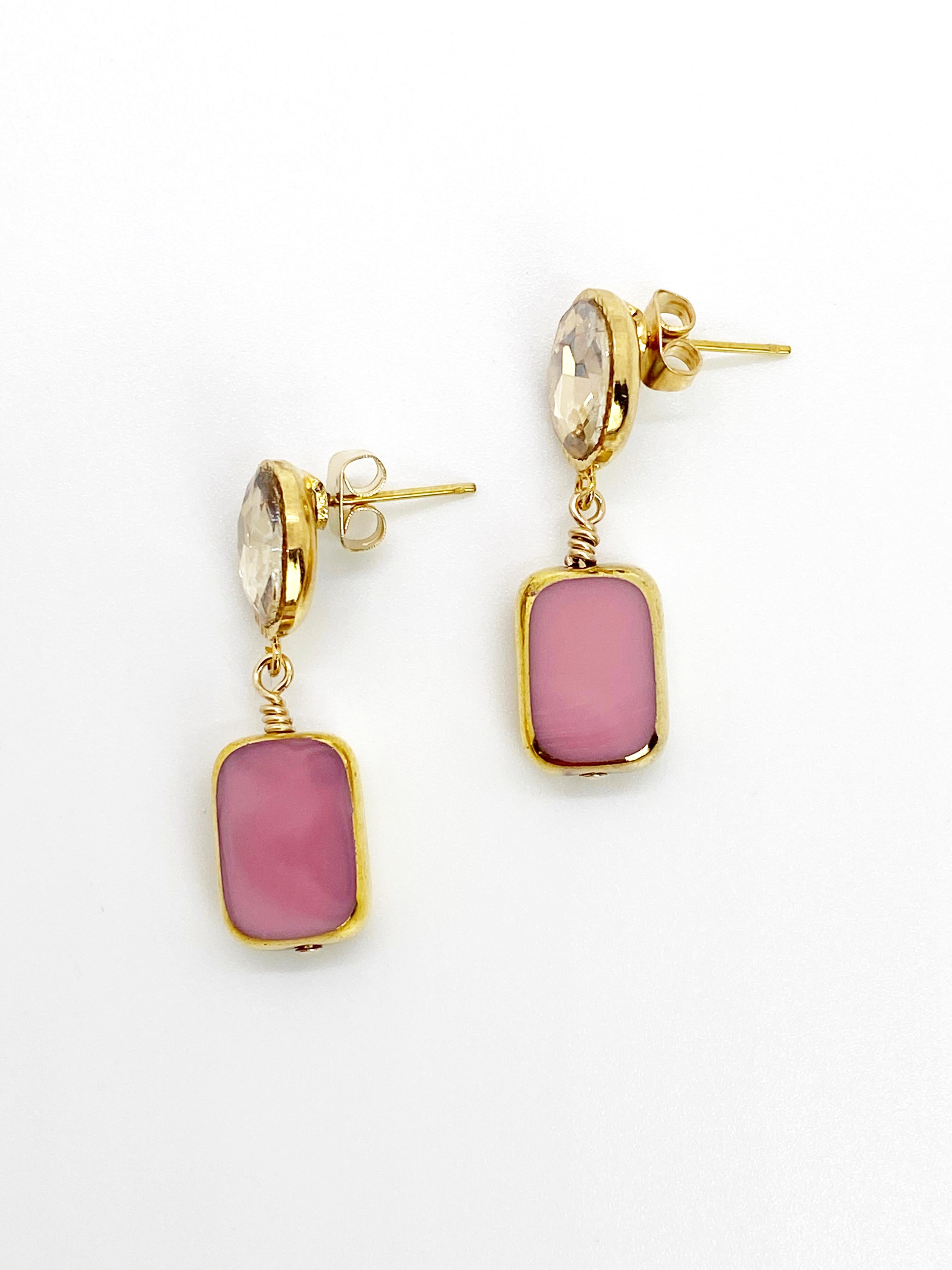 A pastel opaque pink German glass beads edged with 24K gold dangles on a 24K gold plated setting with a champagne cabochon.

The German vintage glass beads are considered rare and collectible, circa 1920s-1960s.

*Our jewelry have maximum protection