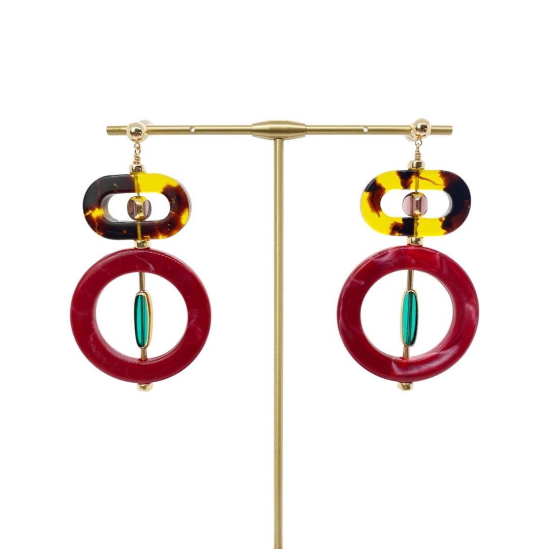 Each earring consist of 2 translucent German vintage glass beads that are framed with 24K gold with 2 vintage lucite rings. They are accented with 14K gold filled rondelle beads and tube beads and are finished with 14K gold-filled ear studs. 

The