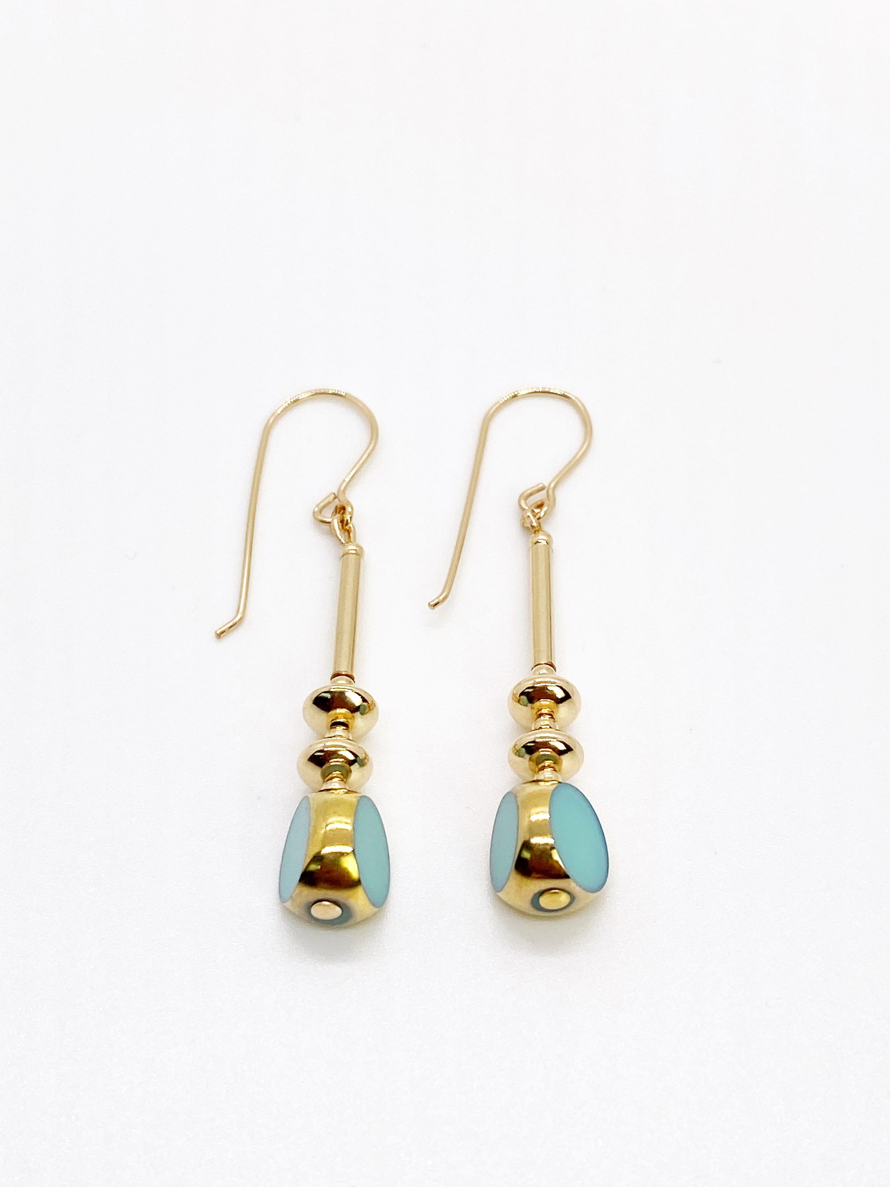 The earrings each consist of 1 beautiful opaque Sea Foam Blue colored window glass beads. The German vintage glass beads that are framed with 24K gold along with gold filled metal beads and wires.

The vintage German glass beads were hand pressed