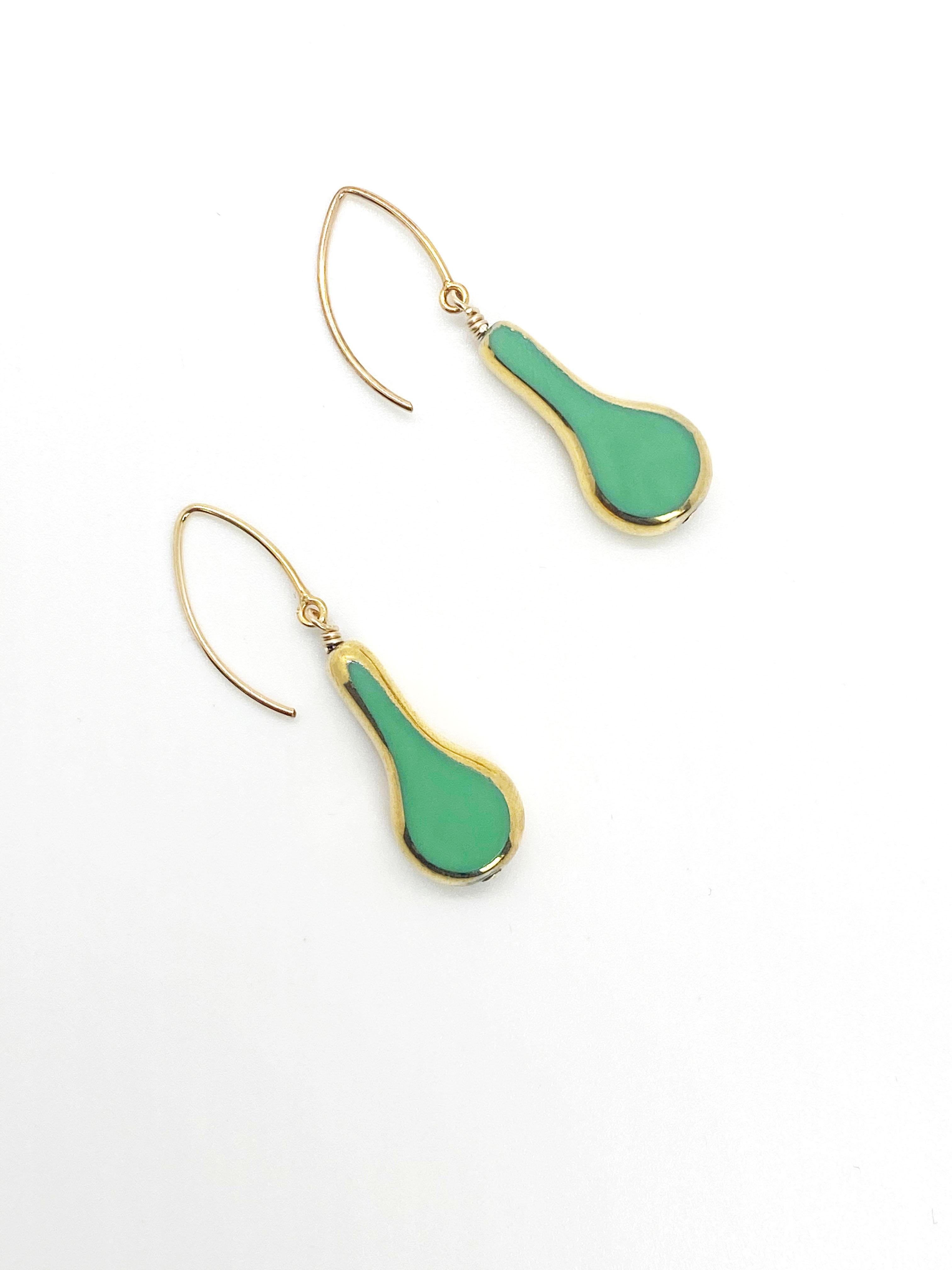 Something simple, fun annd different. This green banjo earrings are it. They are German vintage glass beads that are framed with 24K gold along with gold filled metal ear wires.

The vintage German glass beads were hand pressed during the 1920s-