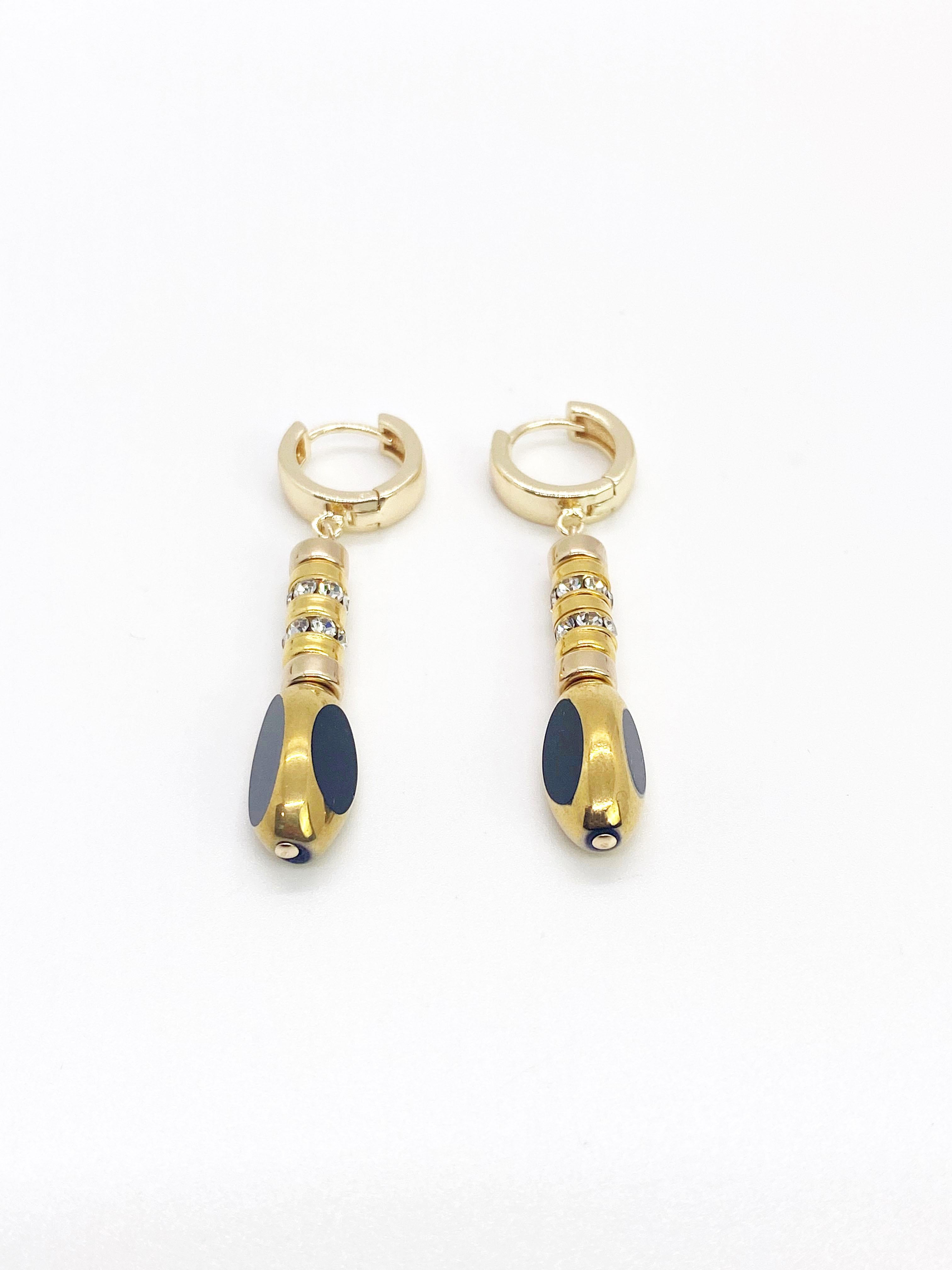 A little edgy and a lot of fun. The earrings consist of black vintage German glass beads along with rhinestones and gold filled rondelle beads. The German vintage glass beads are framed with 24K gold. The earrings are then finished with 18K gold