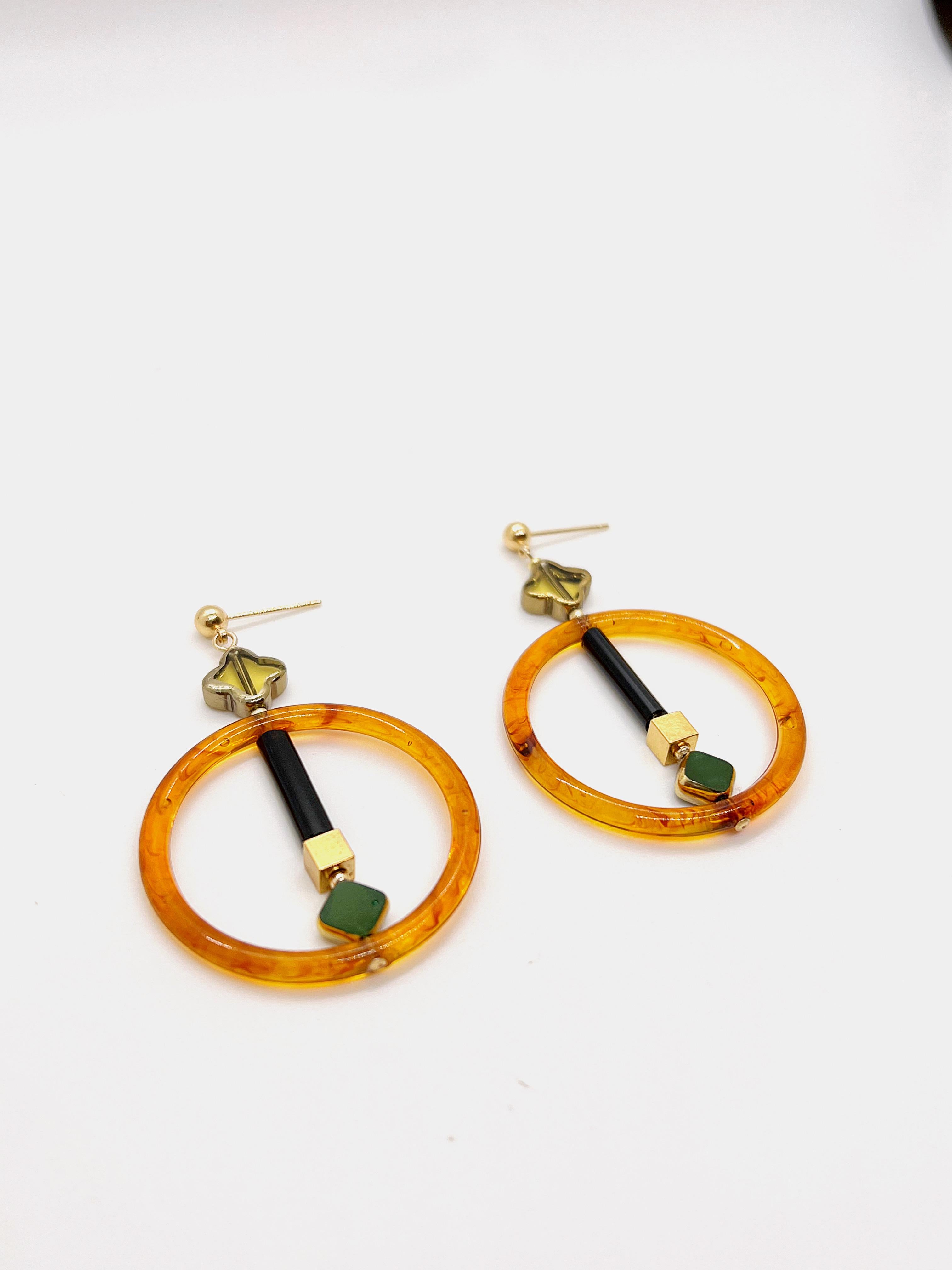 These earrings are light weight and very comfortable to wear all day. Each earring consist of Green vintage German glass beads edged with gold, vintage 4 point star Czech beads, vintage lucite, brass metal plated with 24K gold, gold-filled findings