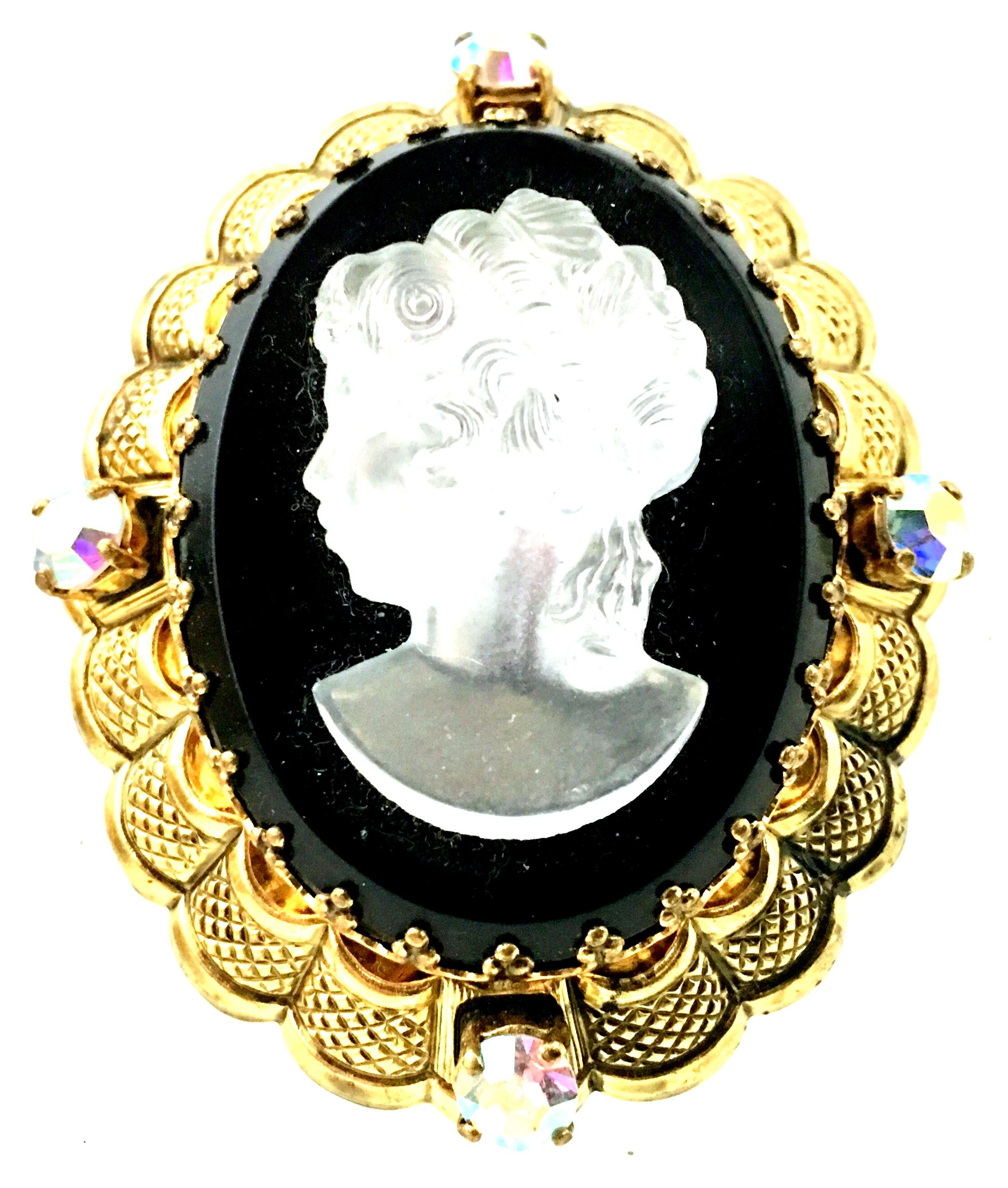 Mid-20th Century Gold Plate Filigree Prong Set Polished & Faceted Carved Glass Cameo Brooch. This mother of pearl carved glass right facing girl cameo sits a top a black faceted glass mount for the incredible dimensional effect. Surrounded by four