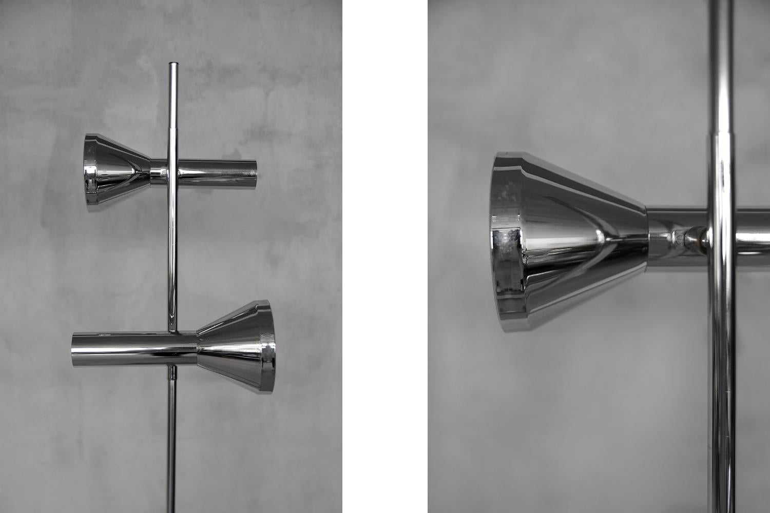 This chrome-plated floor lamp was produced by the German Hustadt Leuchten factory in Neheim during the 1960s. It has two movable reflectors that can be turned on and off separately, and the angle of light can be directed anywhere. This piece has