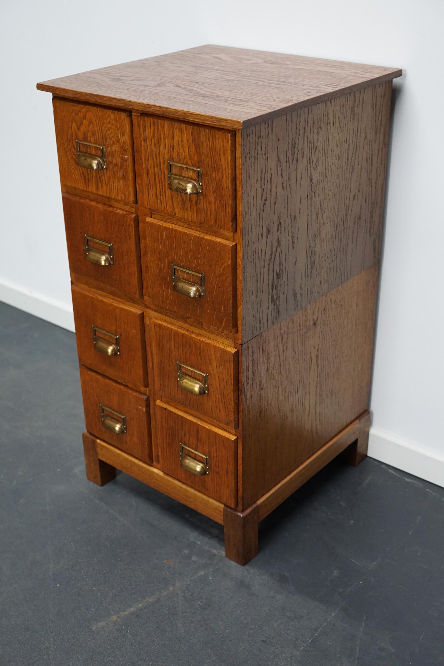 This apothecary cabinet was designed and made circa 1940s in Germany. It features 8 drawers with nice brass handles. The interior dimensions of the drawers are: D W H 34 x 15 x 5 / 12 cm.