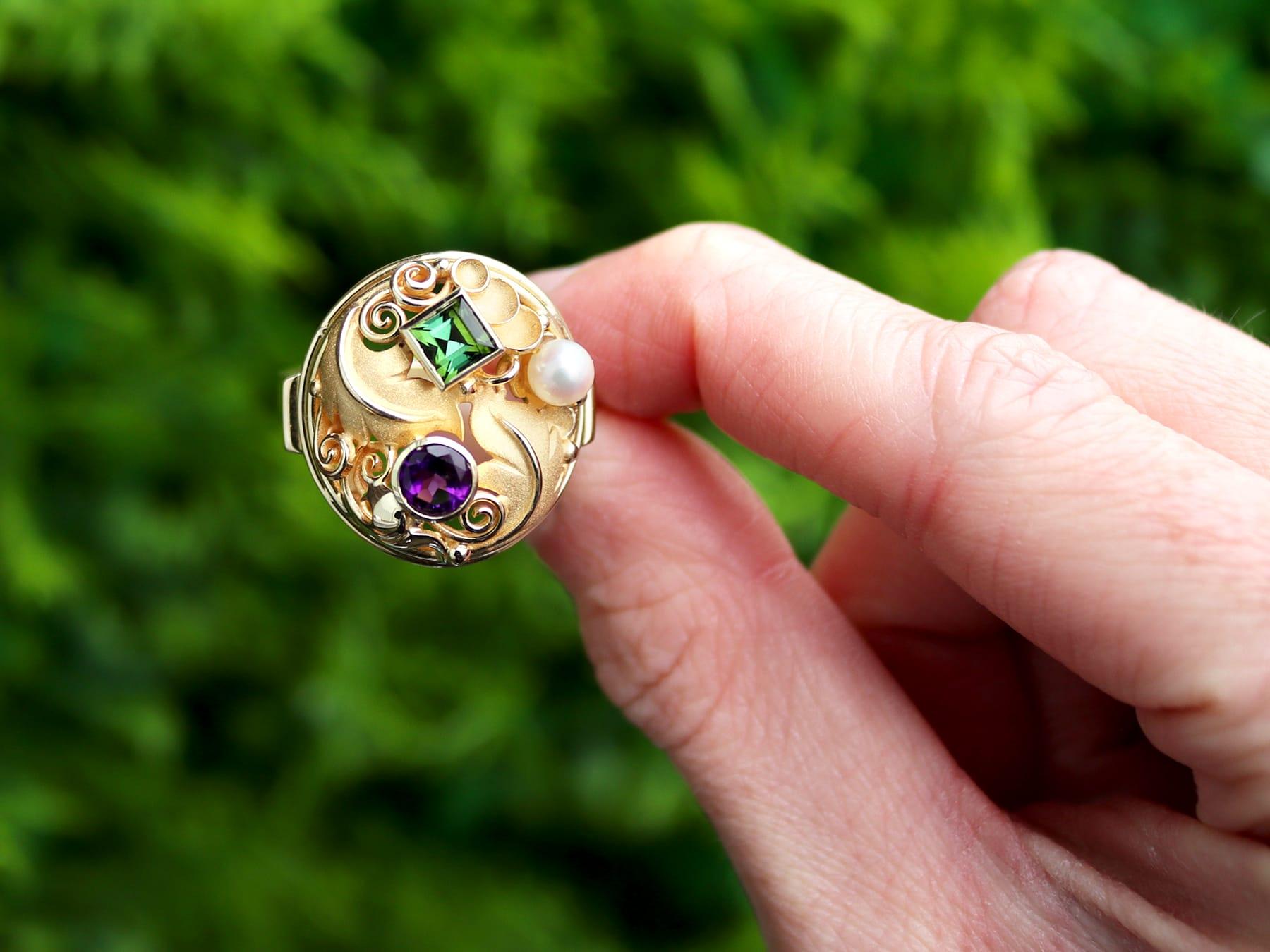 A fine and impressive vintage German 1940's pearl, 0.33 carat tourmaline, 0.30 carat amethyst and 14 karat yellow gold dress ring; part of our dress rings collection.

This fine and impressive vintage dress ring has been crafted in 14k yellow