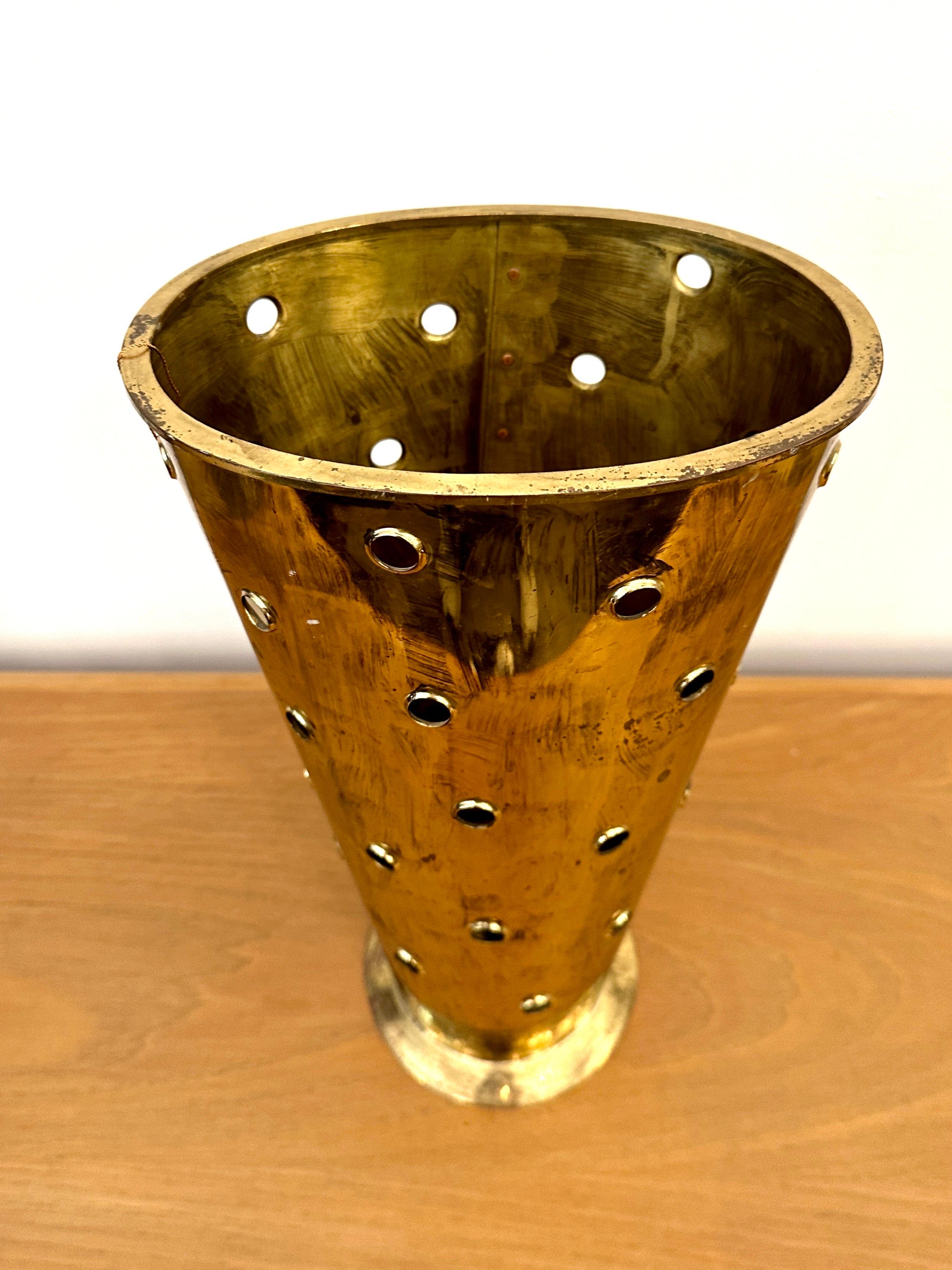 This handcrafted bronze umbrella stand is superb with footed base and playful perforations throughout.  Oval shaped, this shiny bronze fashioned from a single hammered and riveted sheet of patinated bronze.   THIS ITEM IS LOCATED AND WILL SHIP FROM