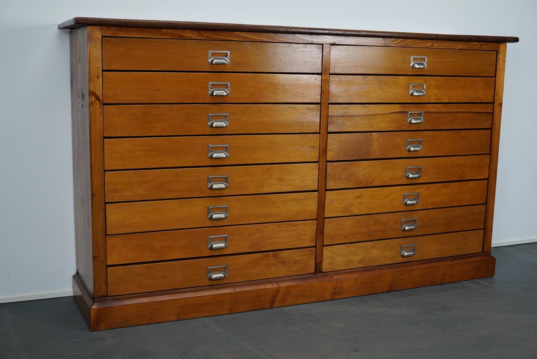 This apothecary / filing cabinet was produced during the 1950s in Germany. This piece features 16 drawers. The interior dimensions of the drawers are: D x W x H 30 x 71.5 x 8.5 cm.