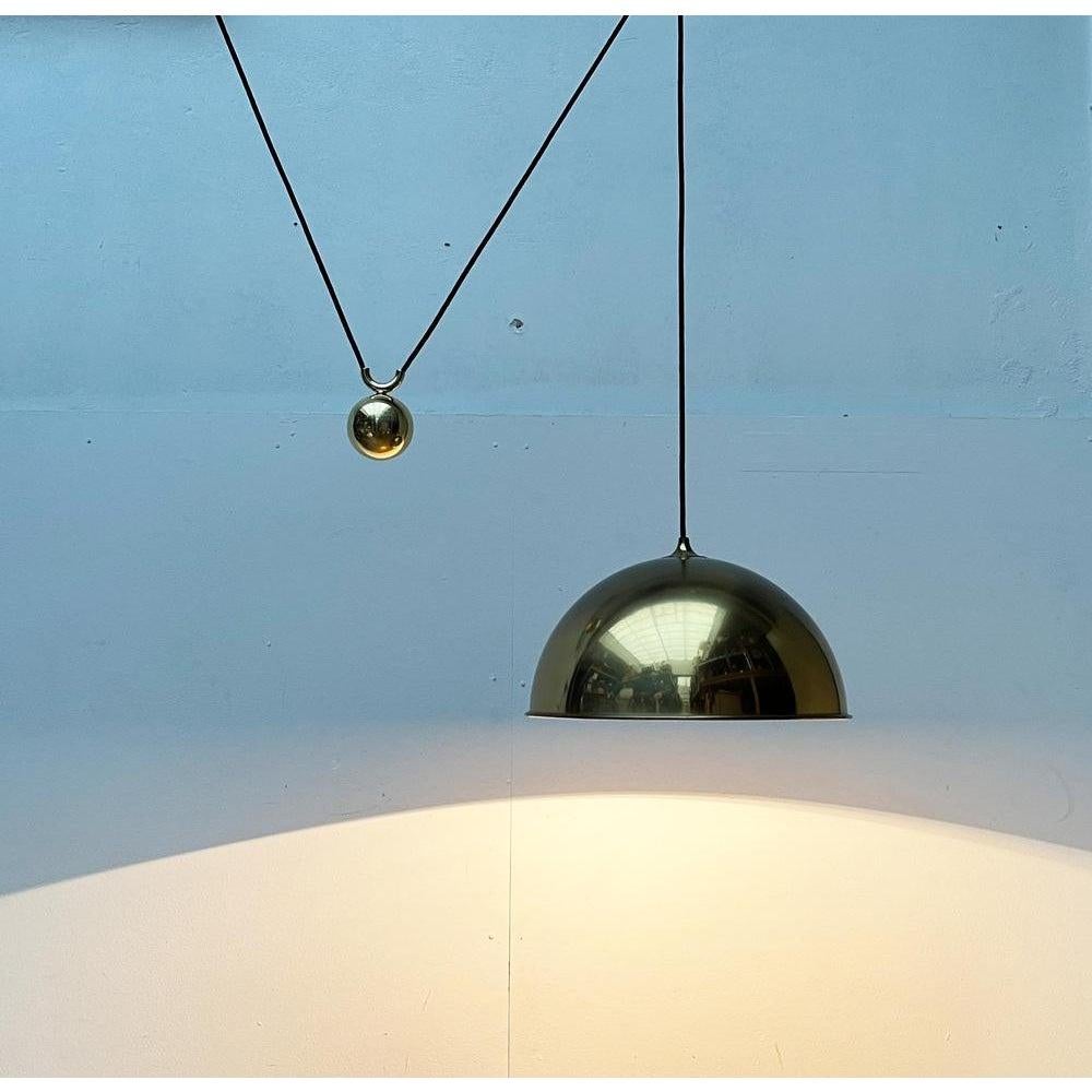 Impressive Counterweight pendant light by German lighting designer Florian Schulz from the early 80s.

The luminaire impresses with its simple elegance and high-quality workmanship and materials. The shade is a simple hemisphere made of heavy brass.