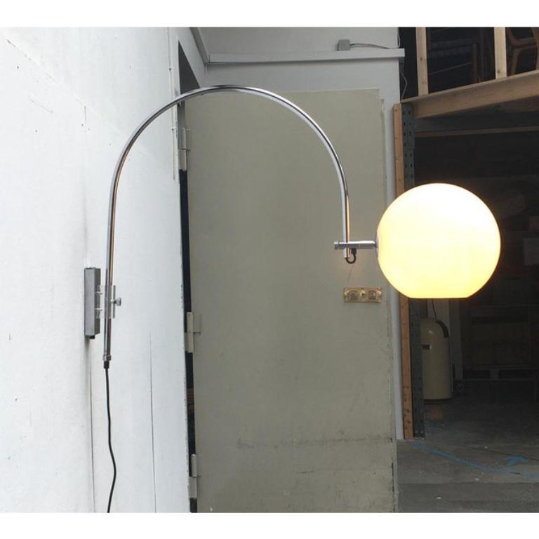 Beeindruckende Space Age-Bogenwandleuchte von Wila.

Besonders auffallend ist der weit auskragende Bogen des Leuchtenarms, an dessen Ende eine große Kugel als Diffusor sitzt. Die Kugel aus durchsichtigem Kunststoff hat am Boden eine kleine Öffnung.
