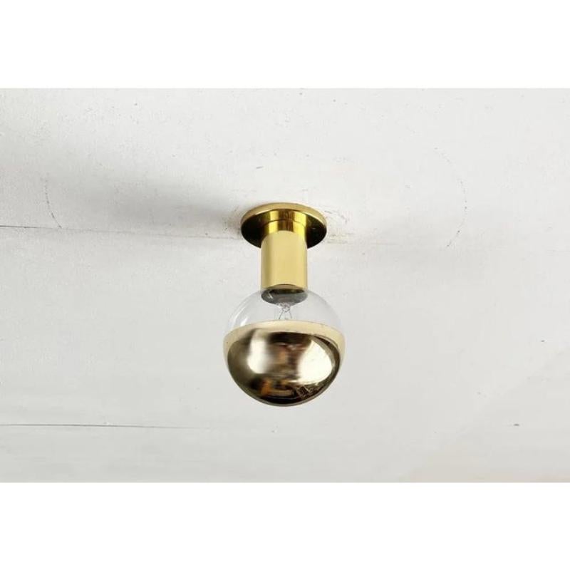 Imposing mid century ceiling or wall light from staff according to a design by the japanese designer motoko ishii. Here in a rare version in brass with gold -colored mirrored ball.

This lamp can be mounted on the ceiling or wall. Individually, as a