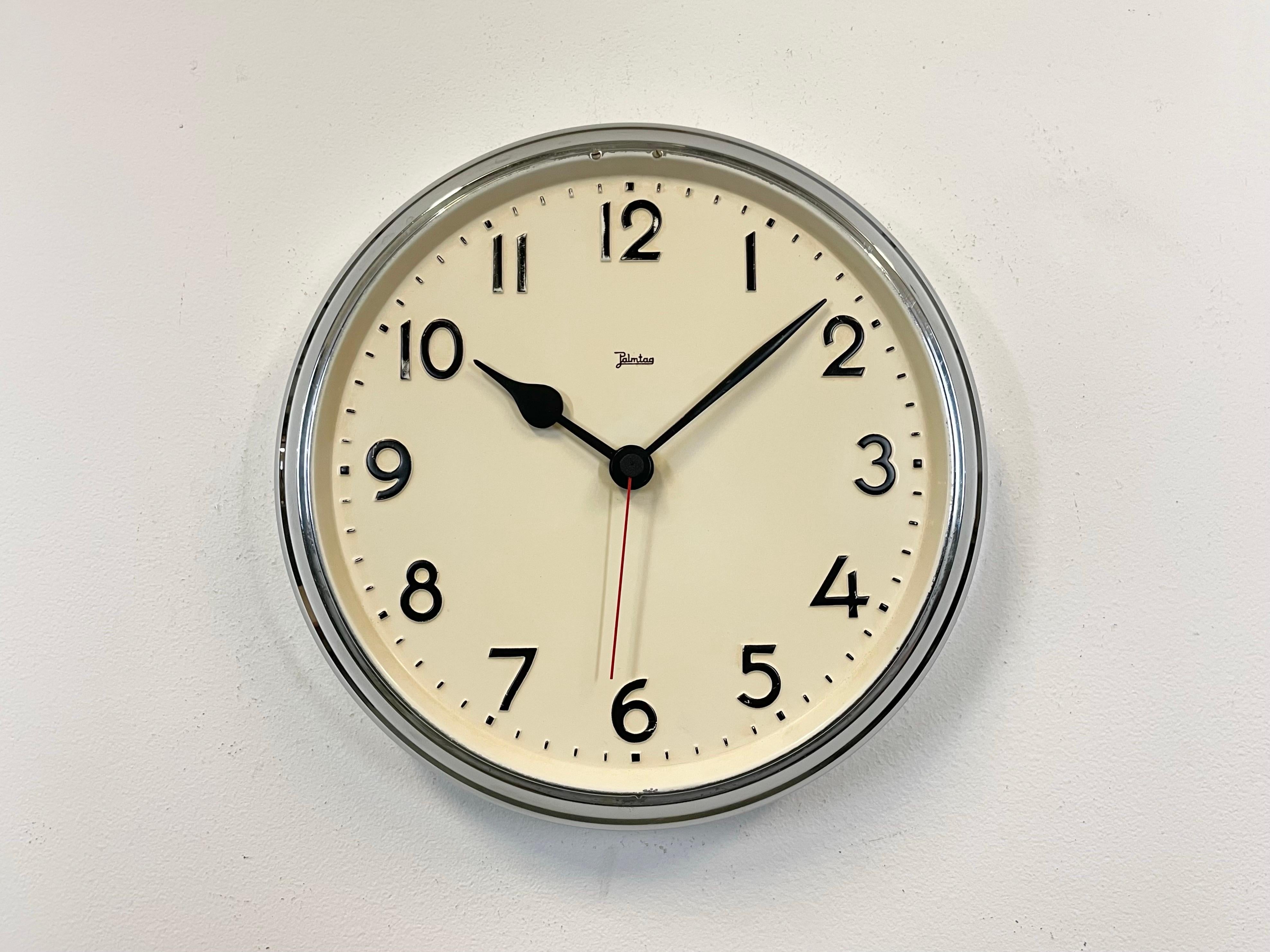 This industrial factory wall clock  was manufactured by Jakob Palmtag of Schwenningen in Germany during the 1950s. It features an iron chrome plated frame, an iron dial and an aluminium hands. Former factory slave clock has been converted into a