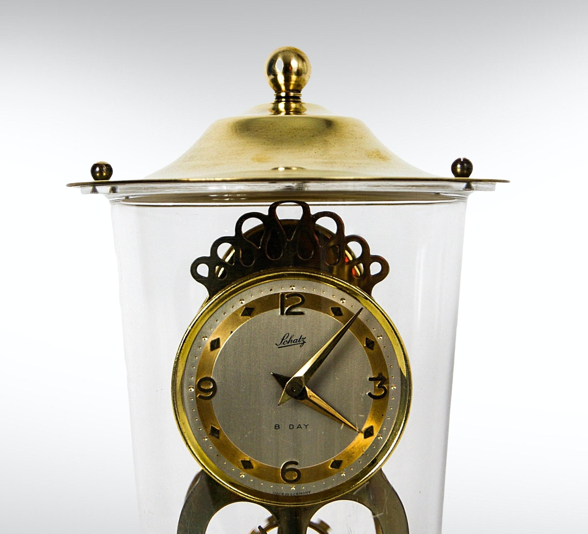 Schatz Germany 8 Day domed mantle/desk clock.
Beautiful kinetic movement.
Made of solid brass with a detachable lucite acrylic and brass domed cover.
Ideal as a mantle or desk clock.

Offered in excellent vintage condition and in fine working