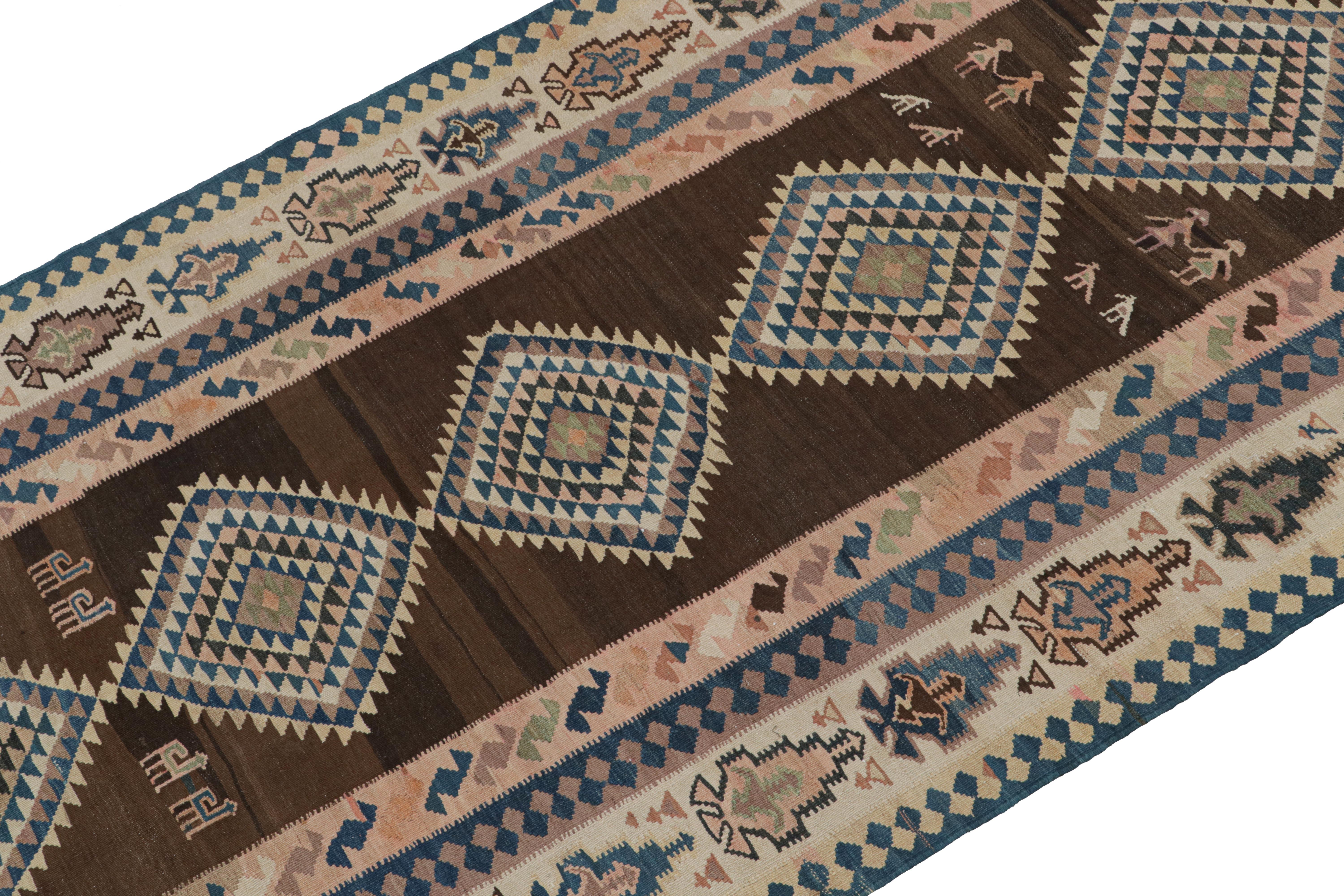 This vintage 5x12 Persian Kilim is believed to be a tribal rug from the Ghazvin region—handwoven in wool circa 1950-1960. 

On the Design: 

This midcentury rug enjoys a rich brown field and beige border, with especially present navy blue and