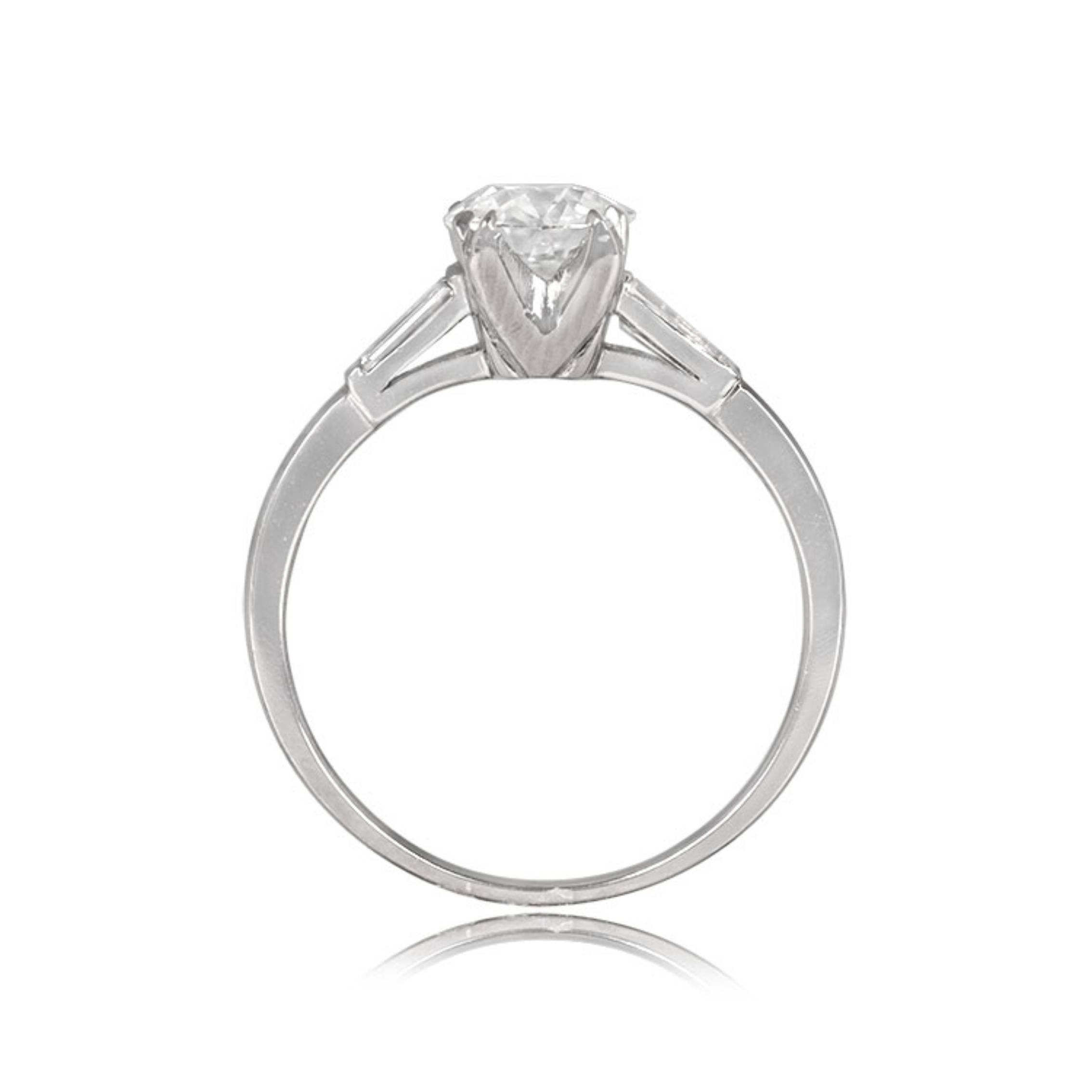 A captivating vintage engagement ring featuring a GIA-certified old European cut diamond from the 1920s, set in prongs. The center diamond, 0.76 carats, I color, and SI1 clarity exudes timeless elegance. On the shoulders, two tapered baguette-cut