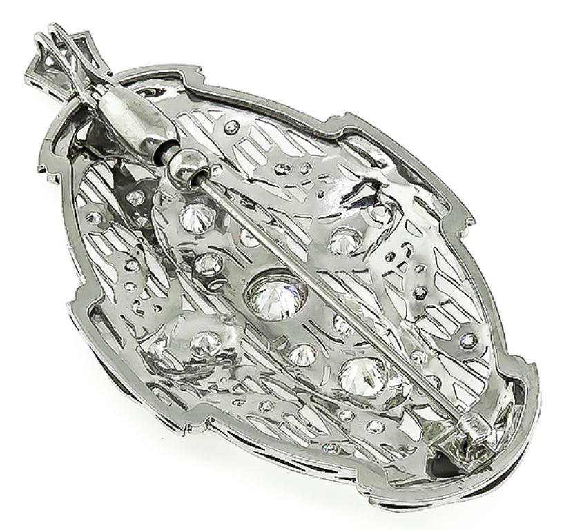 This fabulous 14k white gold pin / pendant from the Art Deco era, is centered with a sparkling GIA certified round cut diamond that weighs 0.81ct. graded J color with VS1 clarity. The center diamond is accentuated by dazzling old mine cut diamonds