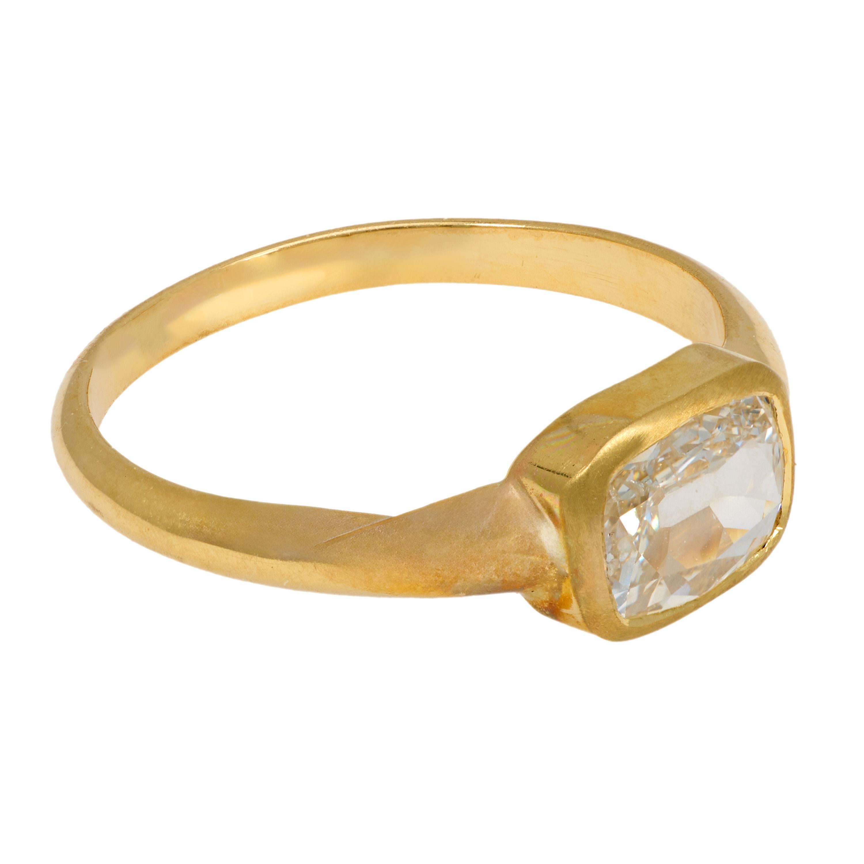 This vintage 18k yellow gold engagement ring features a .92 carat GIA-certified cushion old mine cut diamond, radiating warmth and antique charm. Crafted in the 1990s with timeless simplicity, its golden glow and softly faceted center stone create a