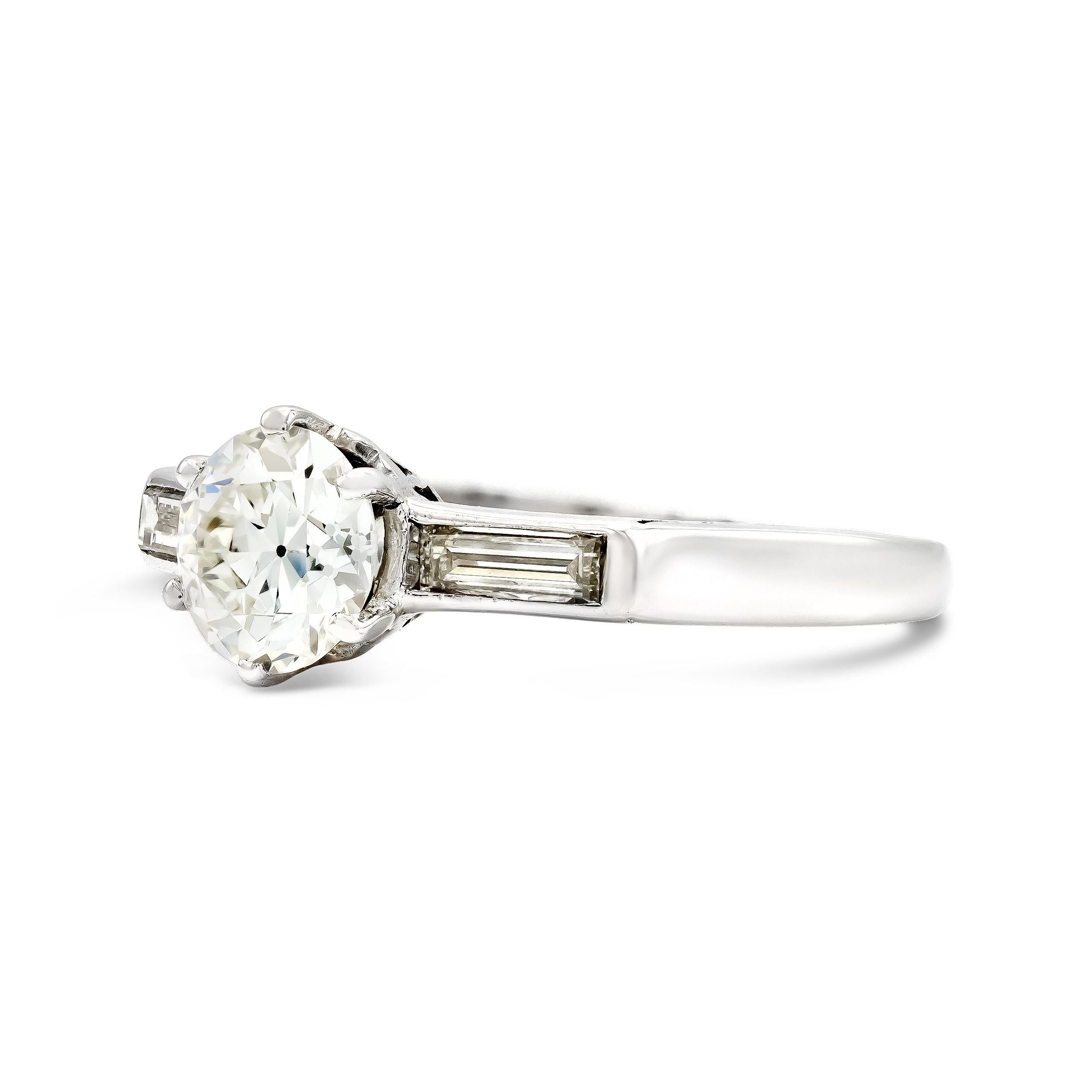 There are few engagement ring styles more classic than this. An antique diamond weighing just a hair under 1 carat centers this vintage engagement ring. We love the sleek six-prong platinum look. Shouldered by two channel-set long and lean straight