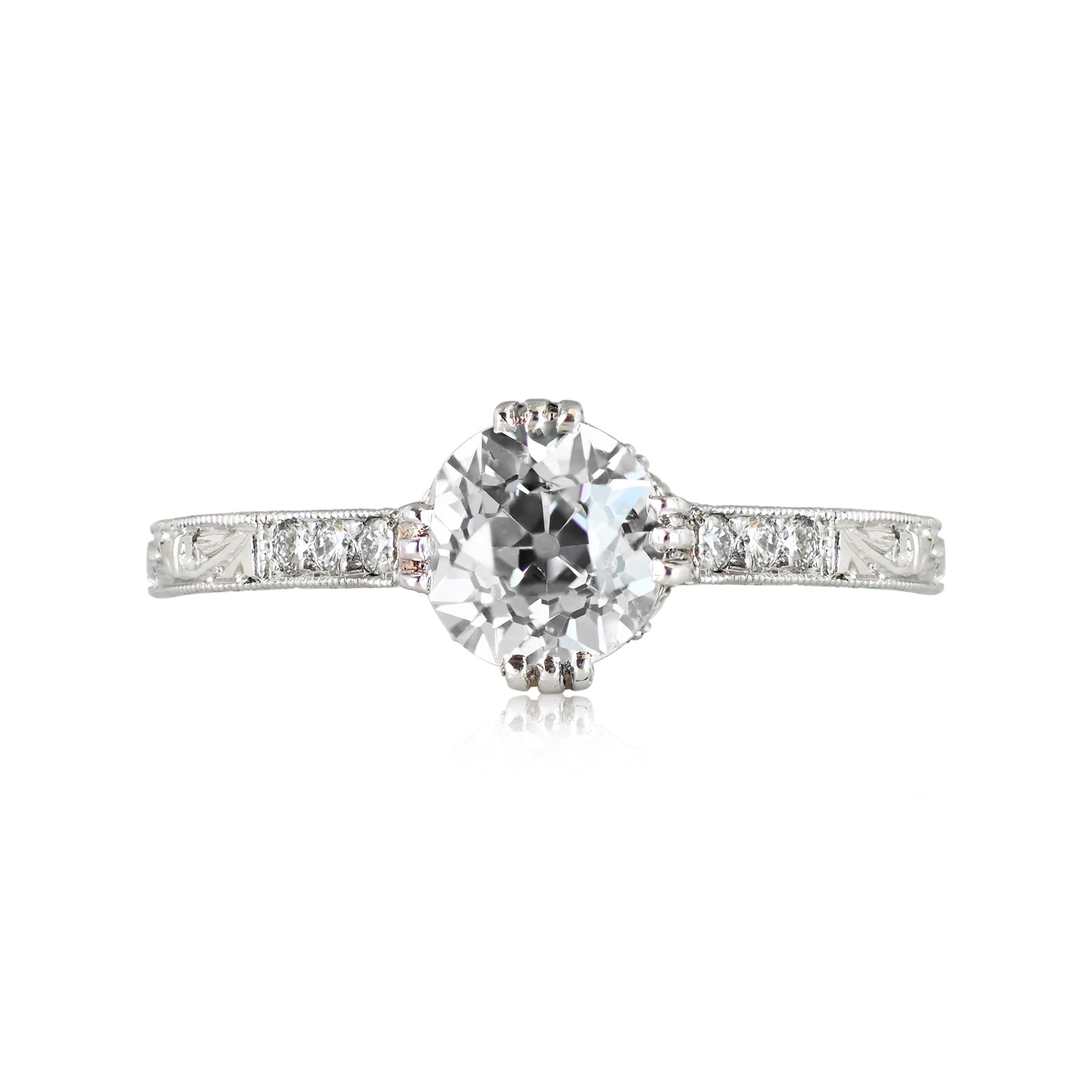 A stunning vintage estate diamond engagement ring, graced with a GIA-certified old European cut diamond in a handcrafted platinum setting. The ring is delicately embellished with diamonds, etching along the shank, and fine milgrain detailing. The