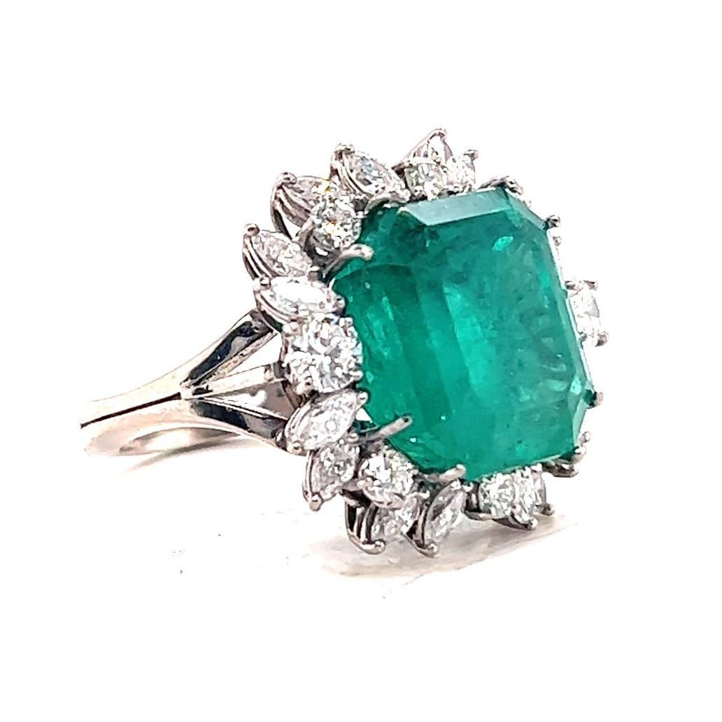 One Vintage GIA 11.30 Carat Emerald Diamond 18 Karat White Gold Cluster Ring. Featuring one square GIA certified Columbian emerald of approximately 11.30 carats, accompanied with certificate #6224307630 stating the emerald is from Colombia. Accented