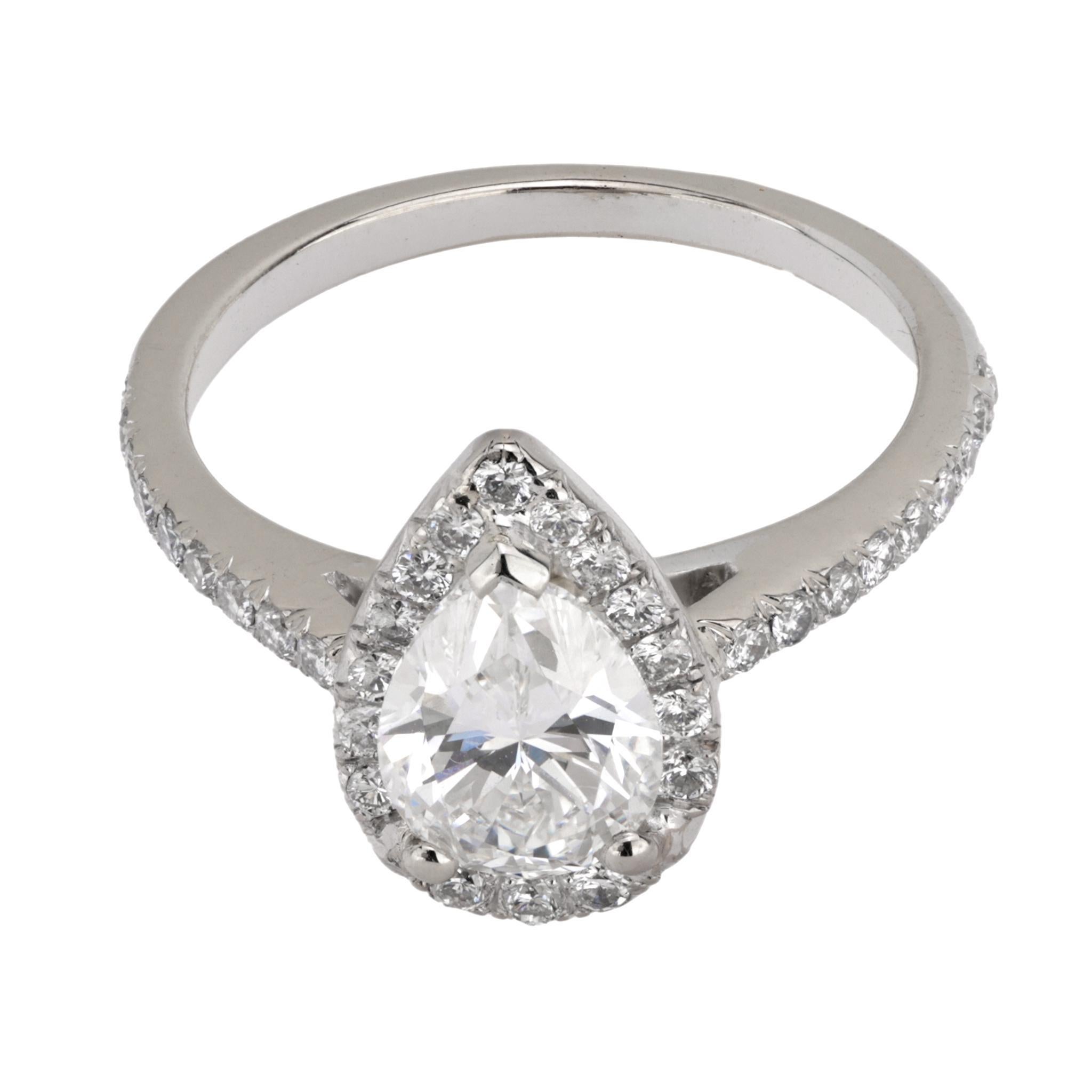 This vintage 18k white gold engagement ring features a GIA-certified 1.14-carat pear-cut diamond, G color, VS1 clarity, accented by 35 round brilliant cut diamonds totaling approximately 0.35 carats, D-E color, VS clarity. Circa 2000s.

Certificate: