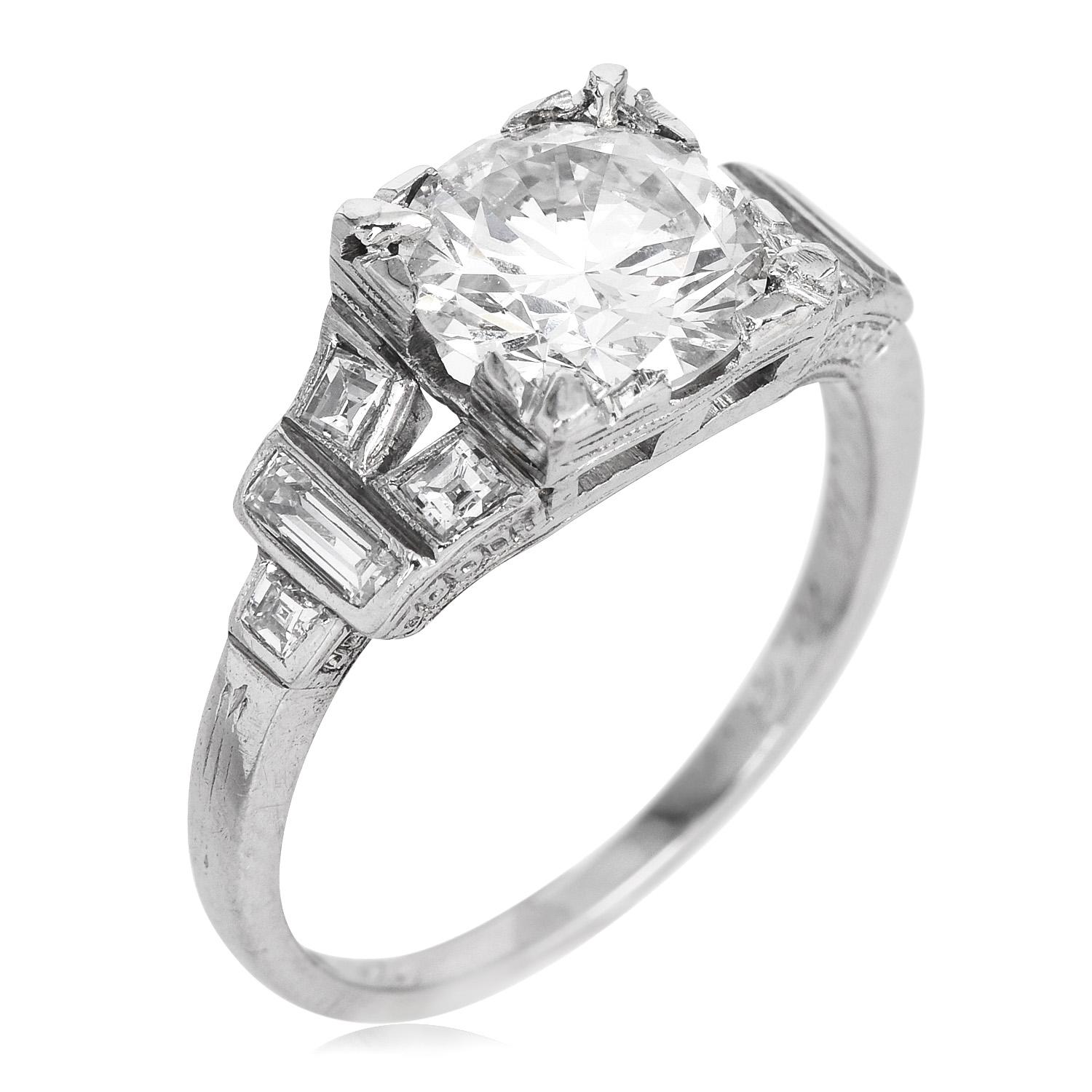 This Vintage mounting is crafted in solid Platinum, the center is adorned by a GIA-certified Round-cut, prong-set Diamond, weighing approximately 1.42 carats, H Color & VS1 Clarity.

Complimenting the sides, there are (8) baguette cut, flush set,