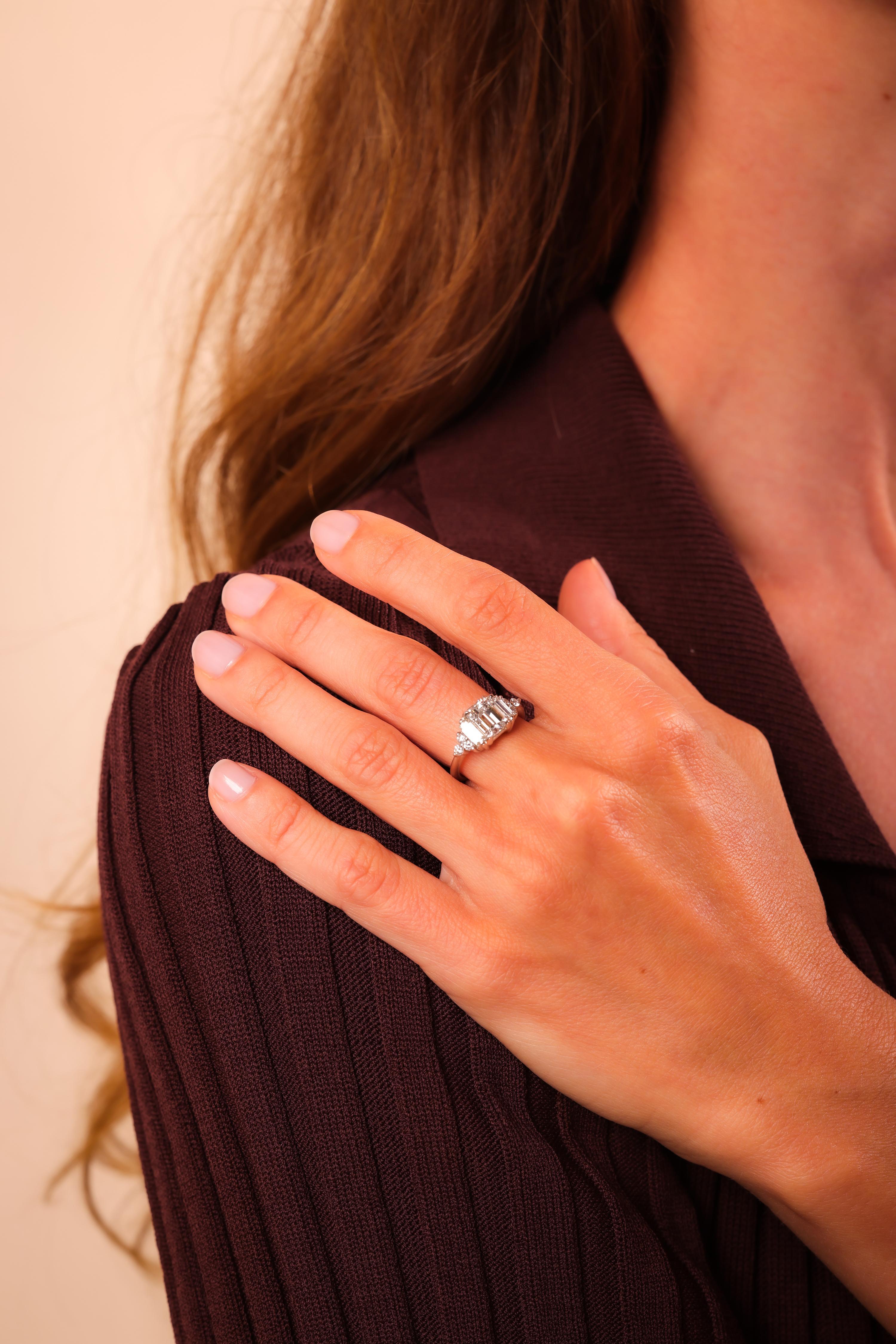 Center Stone: Emerald Cut Diamond
Certificate: GIA  #2225858411
Weight: 1.51 Carat
Color: H
Clarity: VS1
Accent Stone: 6 Round Brilliant and 2 Baguette Cut Diamonds
Weight: Approximately .50 Carats
Color: H
Clarity: Vs
Metal: Platinum 
Era: