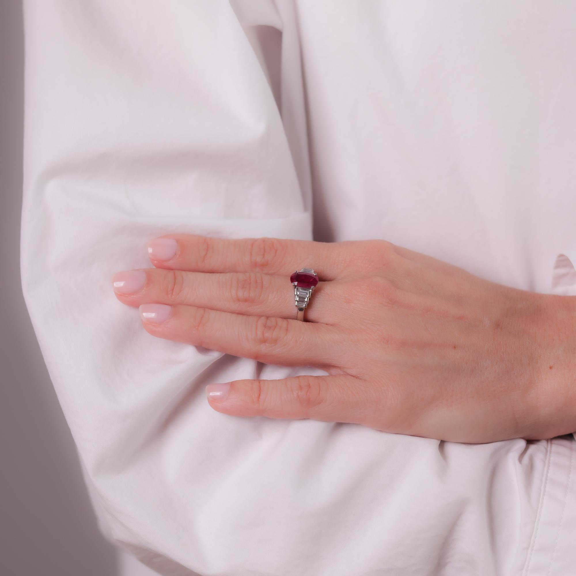 This vintage platinum ring features a GIA-certified 2.03-carat oval-cut Burmese ruby, heated, accented by six baguette-cut diamonds totaling 0.47 carats, D-E color, VS clarity. Circa 1980s.

Certificate: GIA #3485743753
Center stone: Oval cut