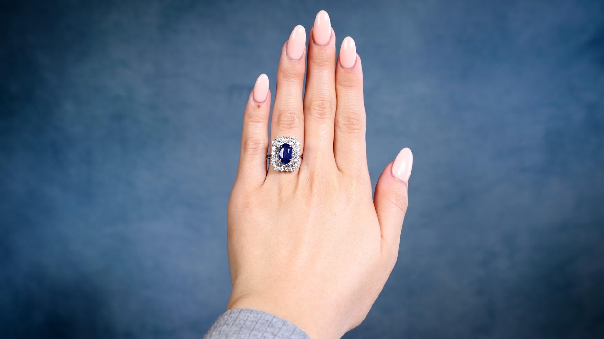 One Vintage GIA 2.08 Carat Ceylon Sapphire 18k White Gold Double Halo Ring. Featuring one oval mixed cut of 2.08 carats, accompanied by GIA #2235186786 stating the sapphire is of Ceylon (Sri Lanka) origin. Accented by 32 round brilliant cut diamonds
