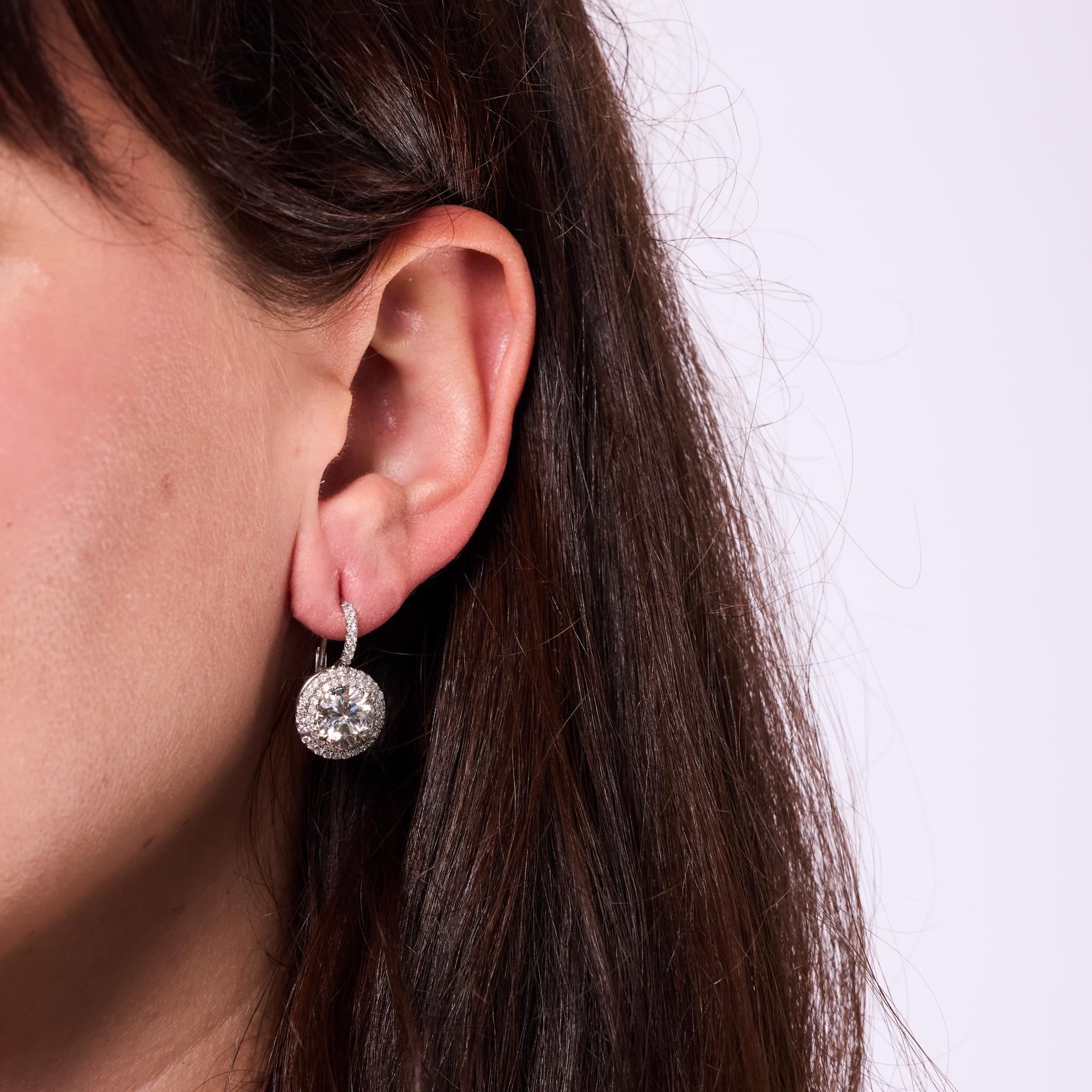 Crafted in the 1980s, these vintage earrings are a dazzling showcase of bold brilliance and timeless elegance. Each features a GIA-certified round brilliant cut diamond—2.14 carats (I color, I2 clarity) and 2.11 carats (H color, I2 clarity)—as the