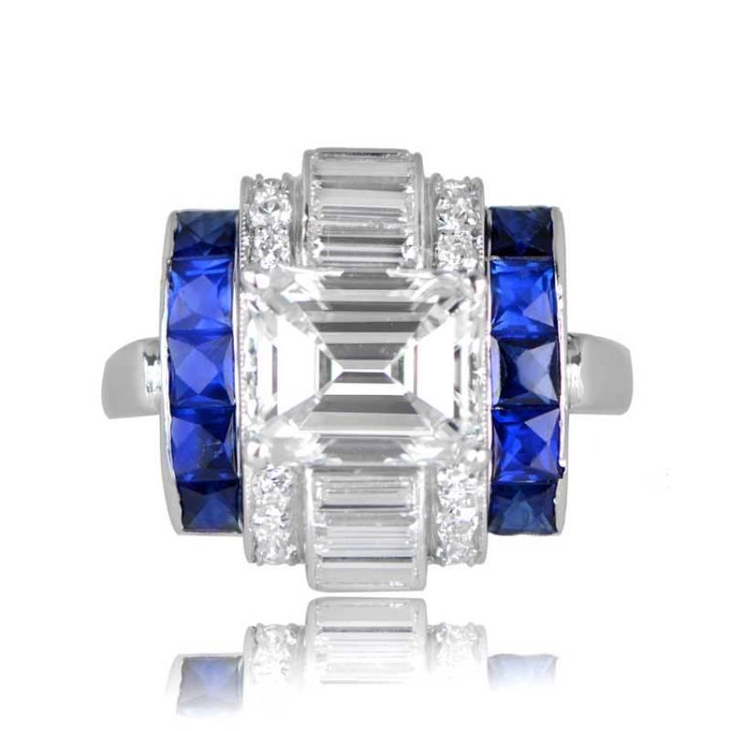 An exquisite vintage ring showcasing a premium GIA-certified emerald-cut diamond, weighing 2.15 carats, with remarkable F color and VVS1 clarity. The ring boasts a distinct tank-scroll motif accented by calibre-baguette cut diamonds, round old cut