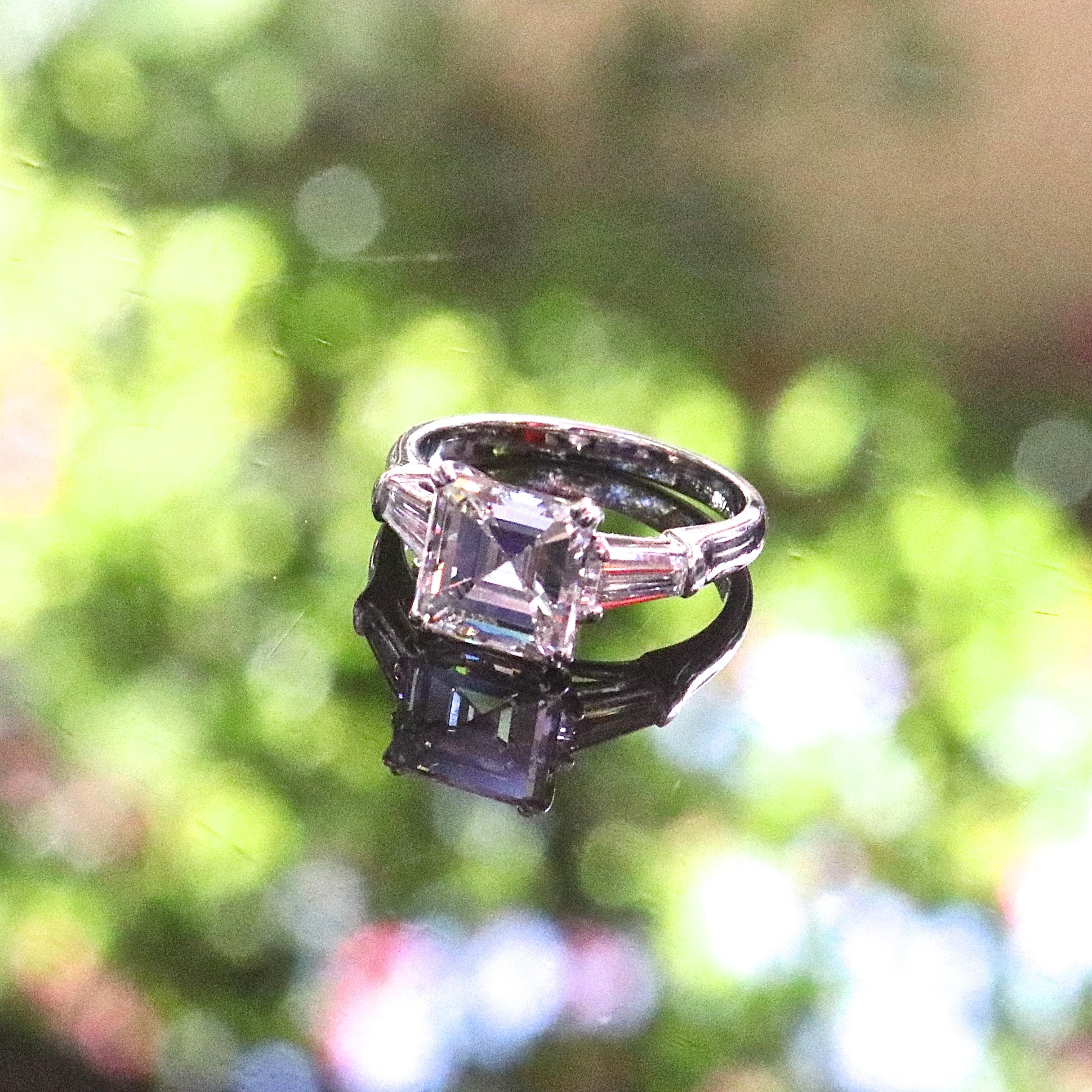 A perfect emerald cut diamond makes for the most beautiful engagement ring. Featuring a 1950's GIA 2.38 carat, J color, VS2 clarity emerald cut diamond. With 2 baguette cut diamonds that weigh approximately 0.25 carats, graded F-G color, VS clarity.