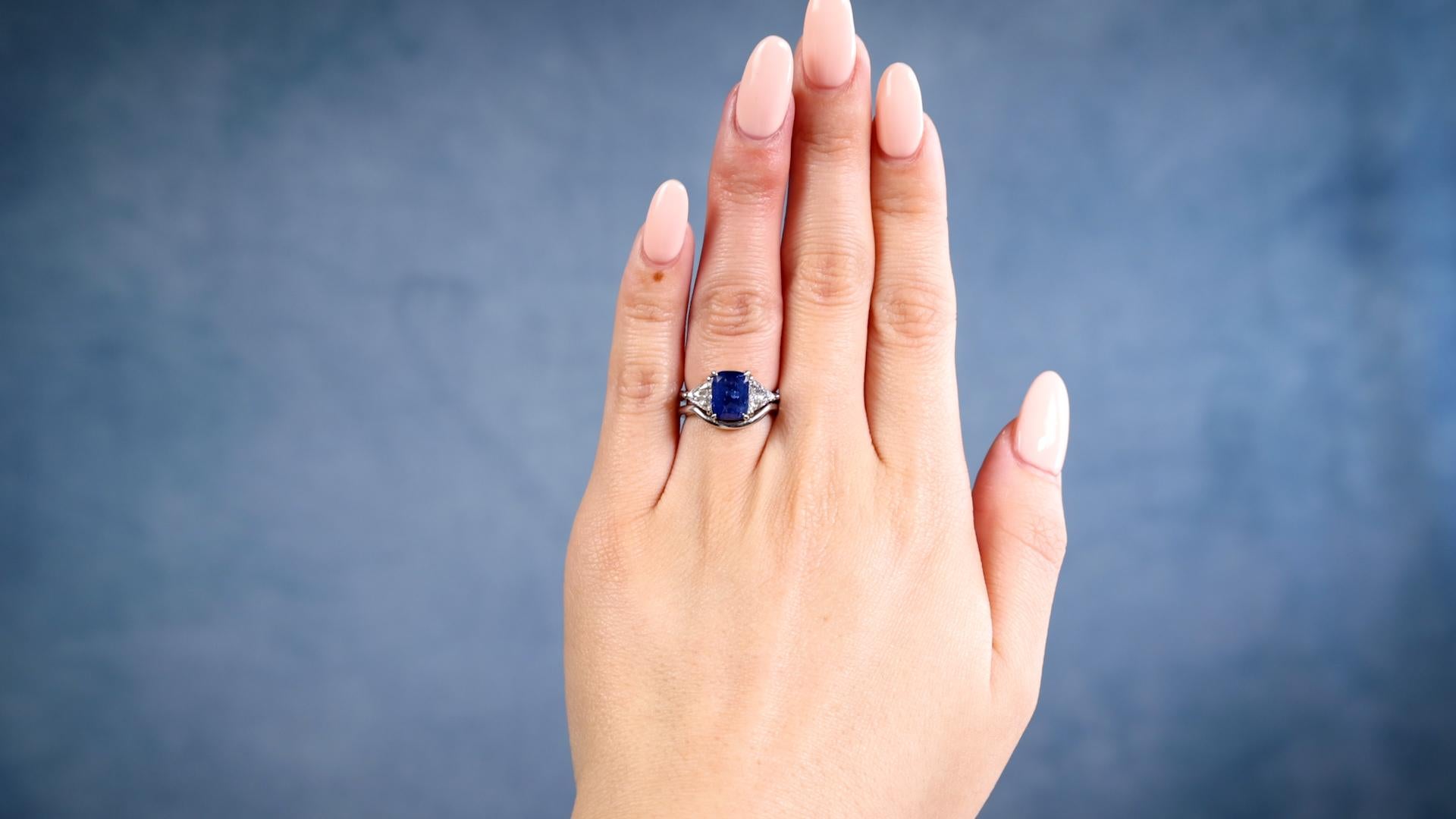 One Vintage GIA 2.66 Carat Ceylon Sapphire Diamond Platinum Ring Set. Featuring one GIA cushion mixed cut sapphire of 2.66 carats, accompanied by GIA #1236197739 stating the sapphire is of Ceylon (Sri Lanka) origin. Accented by two triangular