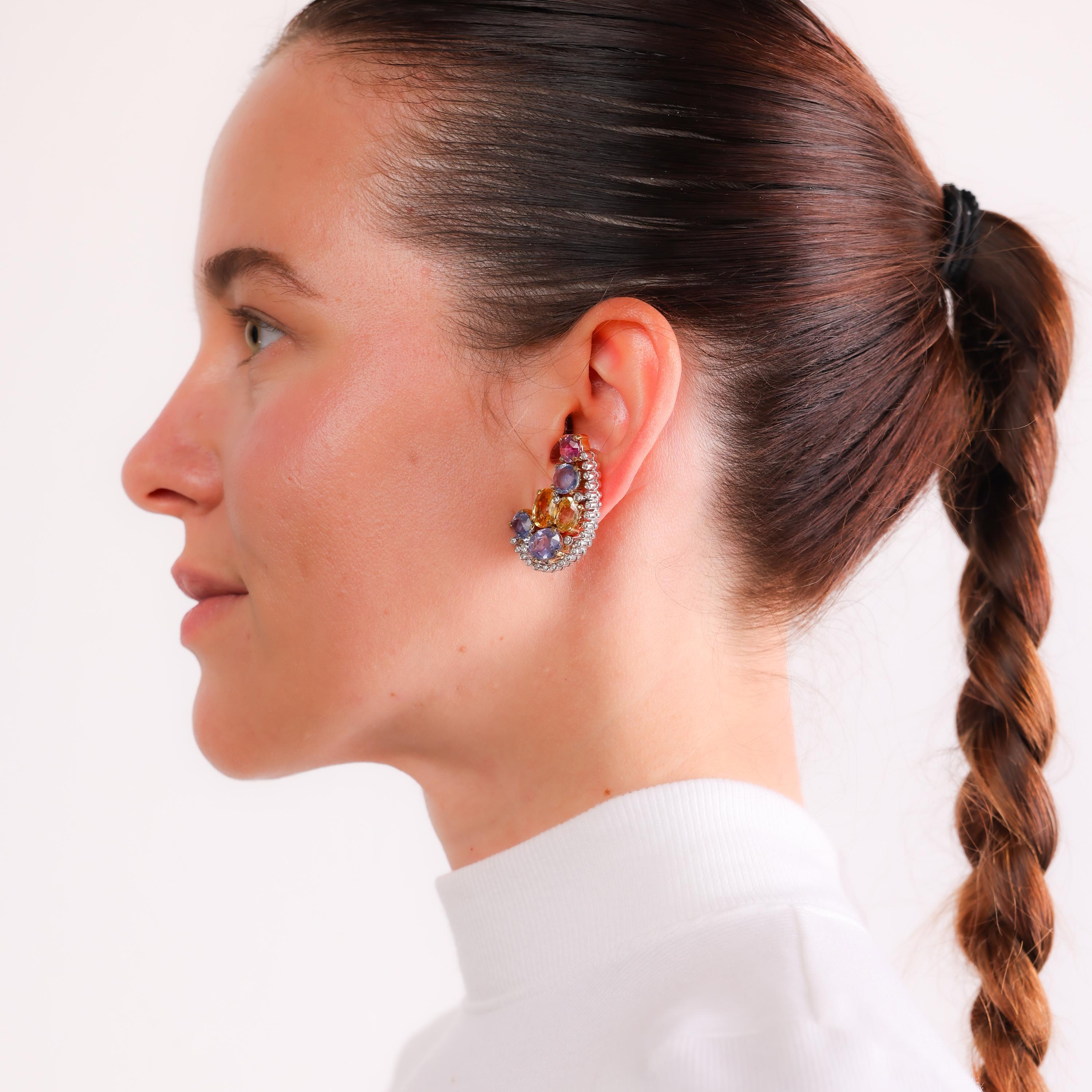 These vintage 1970s earrings in 18k gold and platinum showcase vibrant no-heat Sri Lankan sapphires paired with sparkling diamonds, exuding timeless elegance and sophistication.

Certificate: GIA #2235433056
Center stone: 12 oval mixed cut multi