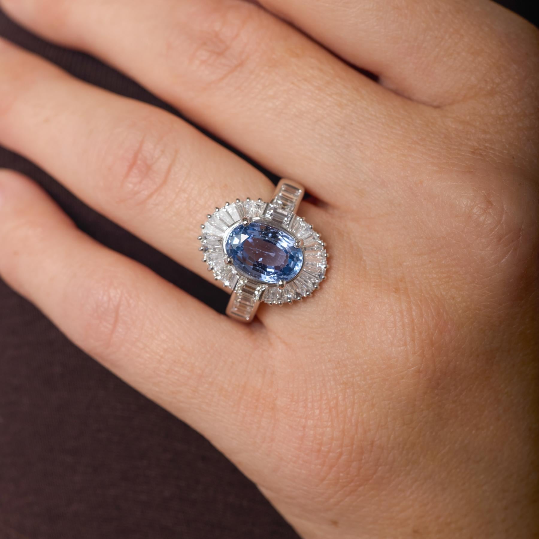 Im Mittelpunkt dieses Vintage-Cocktailrings aus Platin steht ein strahlender, hitzebeständiger Saphir von außergewöhnlicher Reinheit und Tiefe, der von einer strukturierten Anordnung von Baguette-Diamanten umrahmt wird, die ein leuchtendes,