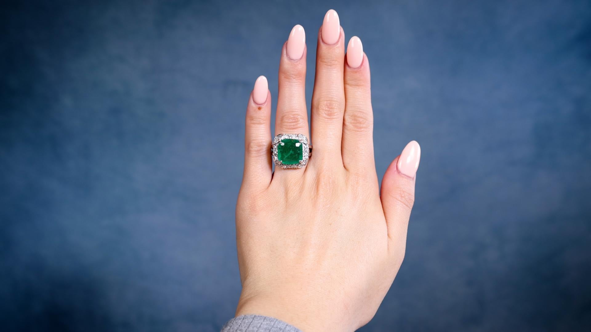 One Vintage GIA 4.00 Carat Zambian Emerald Diamond 14k White Gold Ring. Featuring one GIA cushion mixed cut emerald weighing approximately 4.00 carats, accompanied by GIA #2231188764 stating the emerald is of Zambian origin. Accented by 56 single