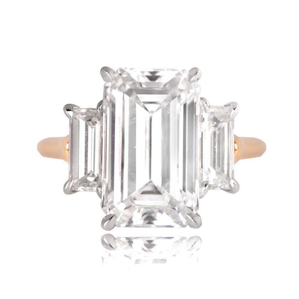 A stunning diamond engagement ring that showcases a GIA-certified 4.02-carat emerald-cut diamond with E color and VS1 clarity. Flanking the center stone are two smaller diamonds, set in a gallery handcrafted in platinum, while the shank is made of