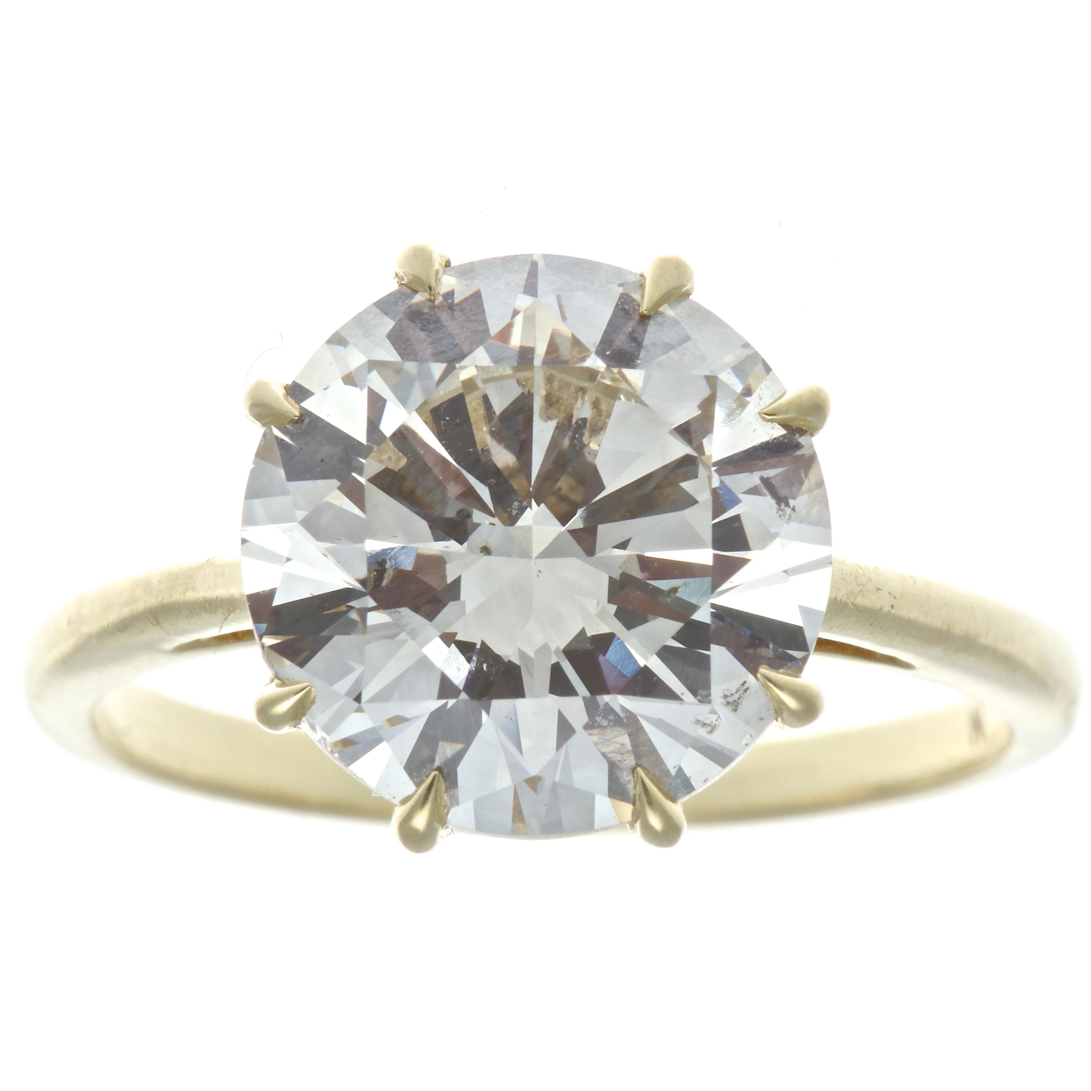 It all starts with a beautiful brilliant diamond. This GIA 4.06 carat round brilliant is graded O-P color, SI2 clarity and was made in the 1950's. Delicately supported in place by many 18k gold prongs, the perfect complement is made to this