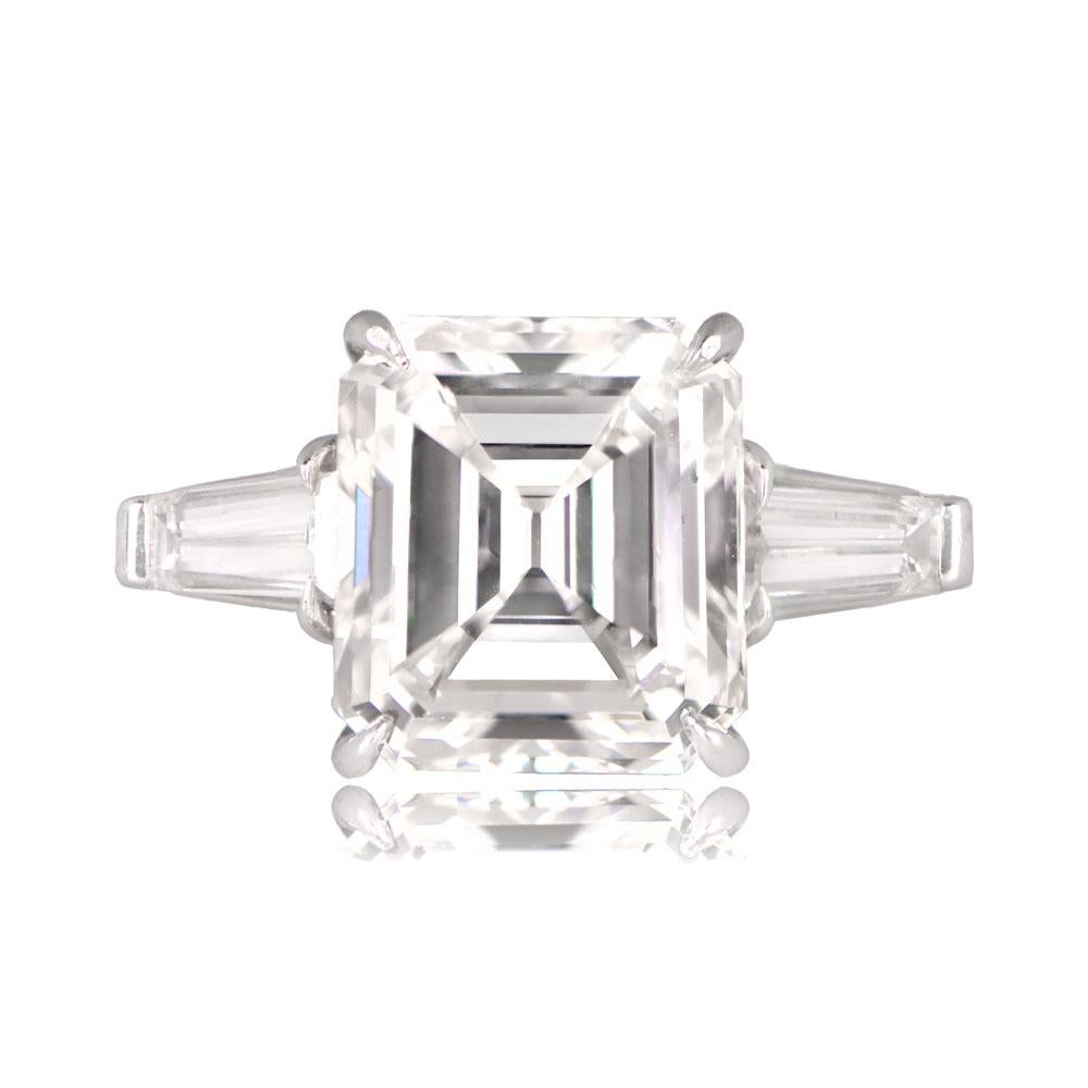 A striking vintage emerald-cut and diamond ring with a central GIA-certified 5.06-carat emerald-cut diamond, boasting I color and VVS2 clarity. The ring features tapered baguette-cut diamonds set along the shoulders and is hand-crafted in platinum.