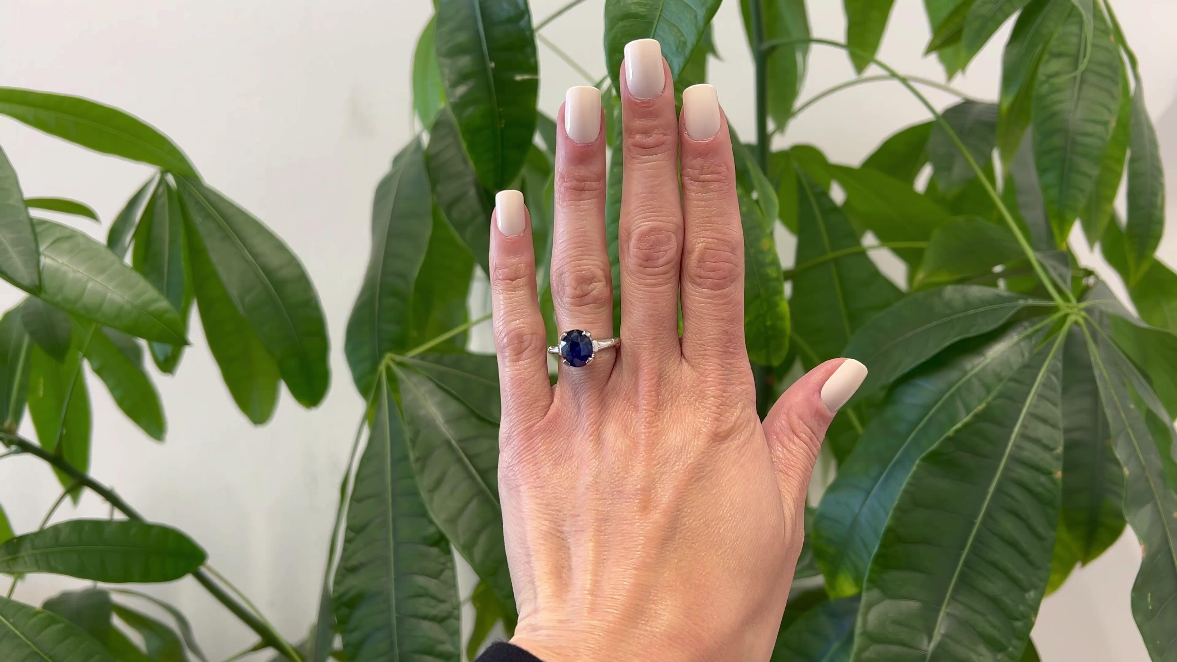One Vintage GIA 5.54 Carat Ceylon Sapphire and Diamond Platinum Ring. Featuring one GIA oval mixed cut sapphire of 5.54 carats, accompanied with GIA #6224960119 stating the sapphire is of Ceylon (Sri Lanka) origin. Accented by two tapered baguette