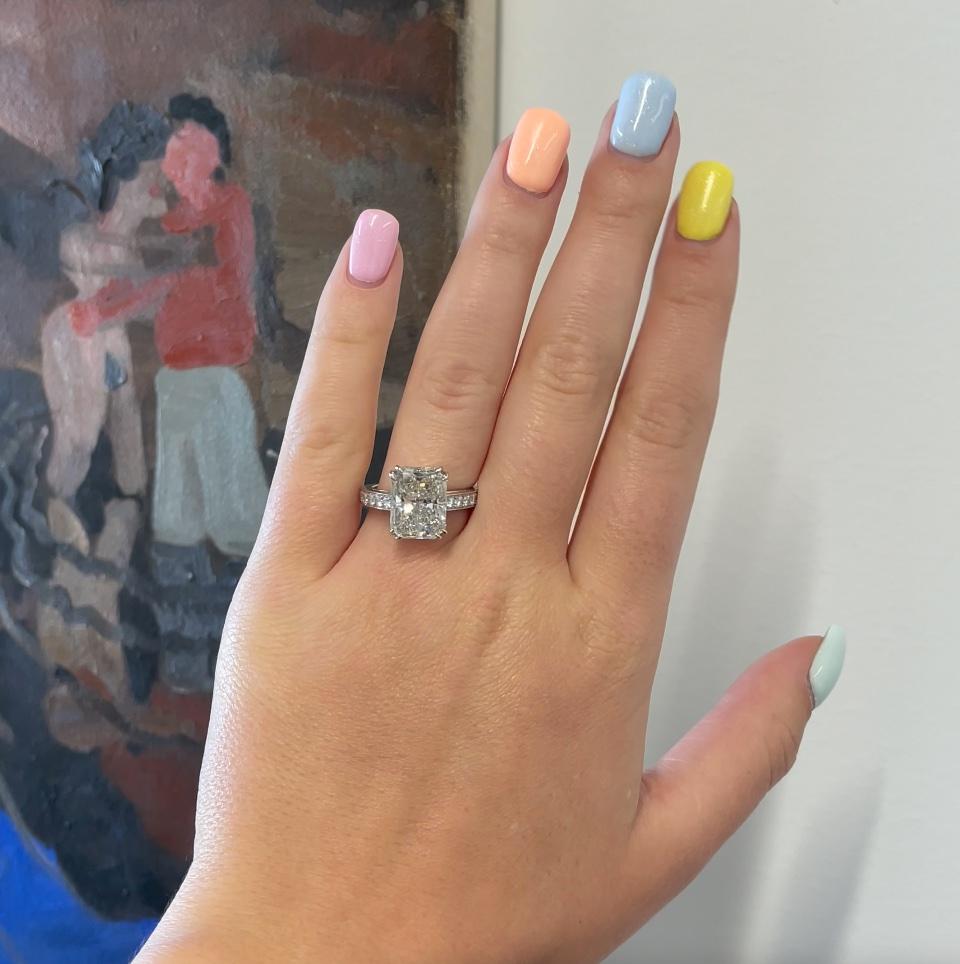 Vintage GIA 6.30 carat Radiant Cut Solitaire Engagement Ring. The diamond is GIA certified radiant cut 6.30 carat, K color, SI1 clarity. Accented by 20 Round Brilliant Cuts, approximately 0.50 carat. Circa 2010s. Size 6 1/2 and can be resized.