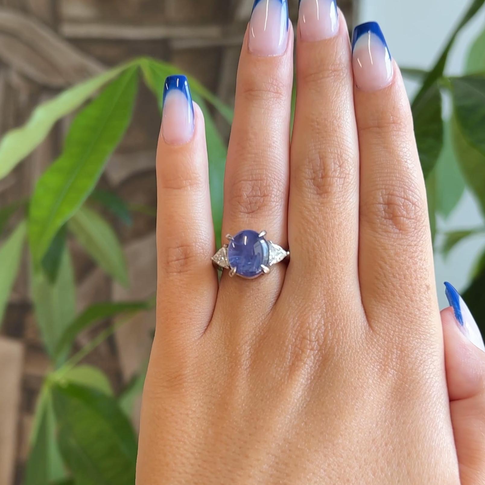 One Vintage GIA 8.73 Carat No Heat Ceylon Color Change Star Sapphire Diamond Platinum Ring. Featuring one GIA certified double cabochon cut violetish blue changing to purple sapphire of approximately 8.73 carats, accompanied with certificate