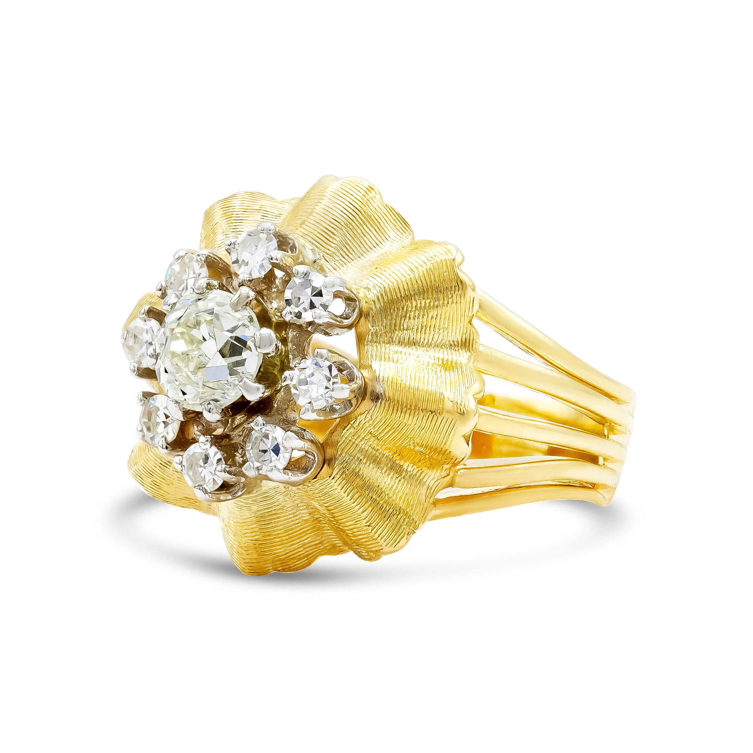 A cluster ring that packs a punch. We love a bold yellow gold ring, especially one that holds 1.50 carats. A perfectly chunky old European cut with a high table and huge culet at the center of this cluster, surrounded by eight other diamonds. We